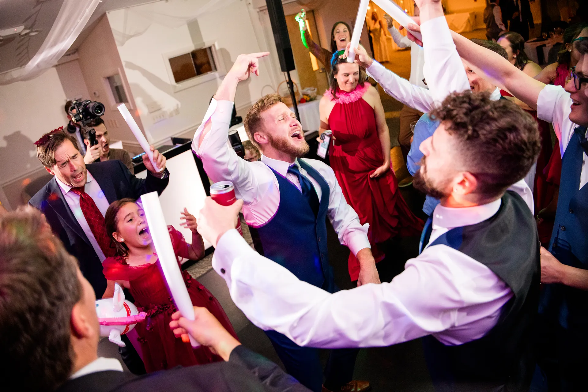 A guests dance around groomsman during a wedding reception at the Atlantic Oceanside Hotel & Event Center in Bar Harbor, Maine.