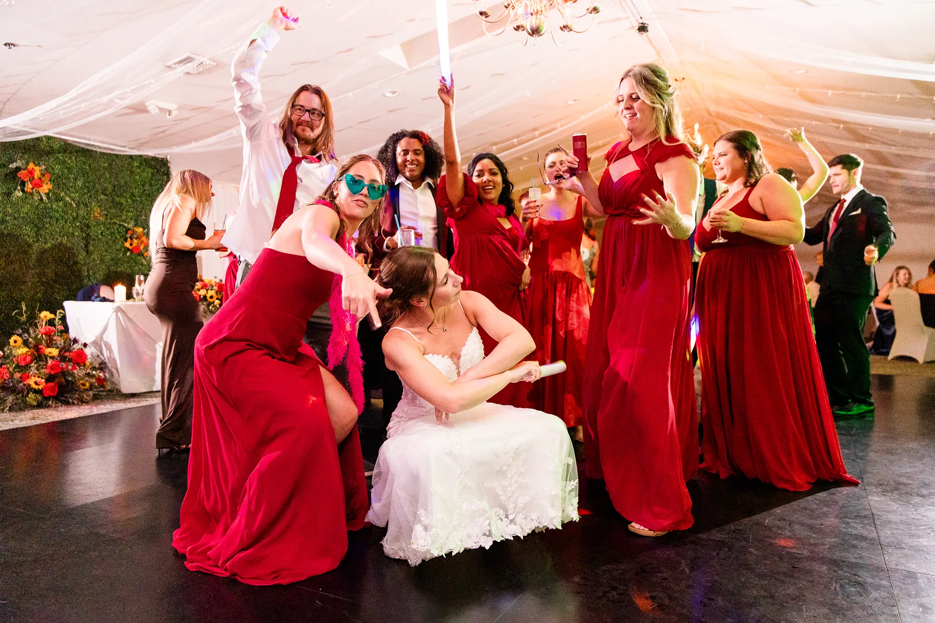 A bride dances with bridesmaids during a wedding reception at the Atlantic Oceanside Hotel & Event Center in Bar Harbor, Maine.