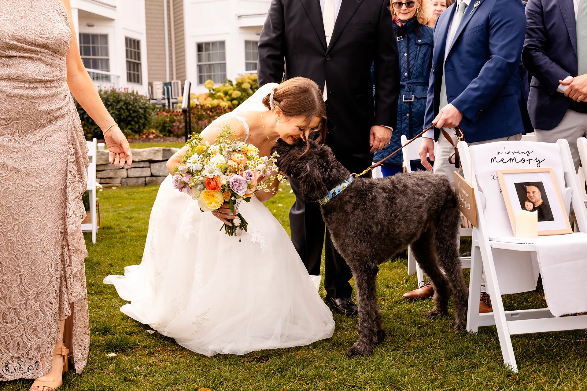 A bride gives her Goldendoodle a hug during a wedding ceremony at the Bar Harbor Inn and Spa near Acadia National Park in Maine.