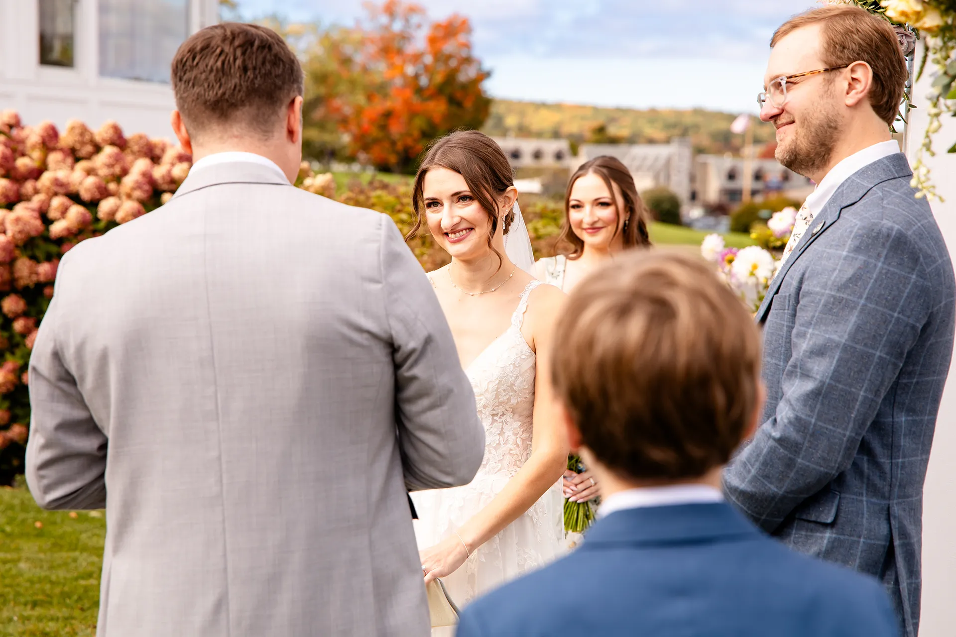 A bride smiles at a groom during a wedding ceremony at the Bar Harbor Inn and Spa near Acadia National Park in Maine.