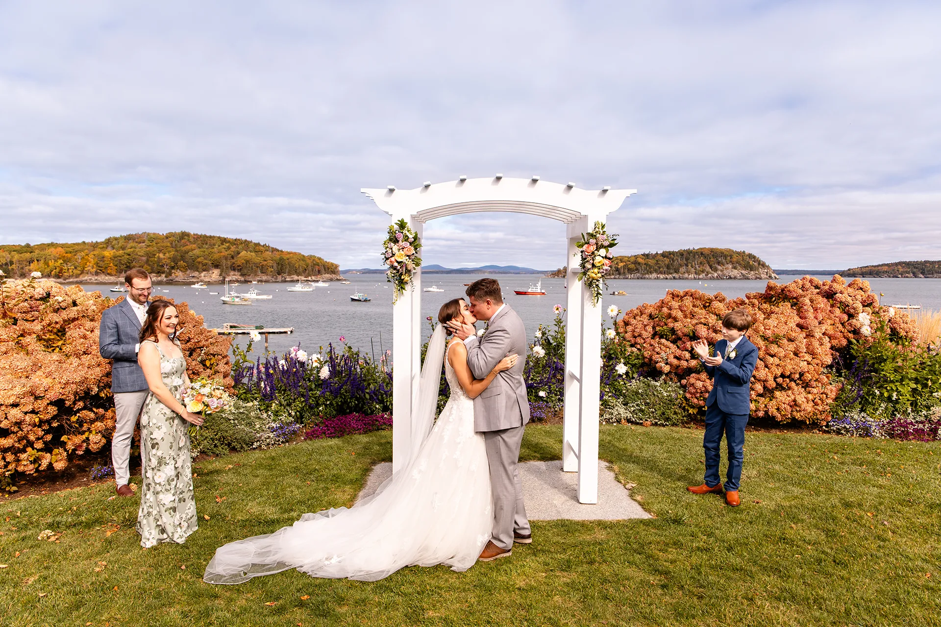 A bride and groom kiss during a wedding ceremony at the Bar Harbor Inn and Spa near Acadia National Park in Maine.