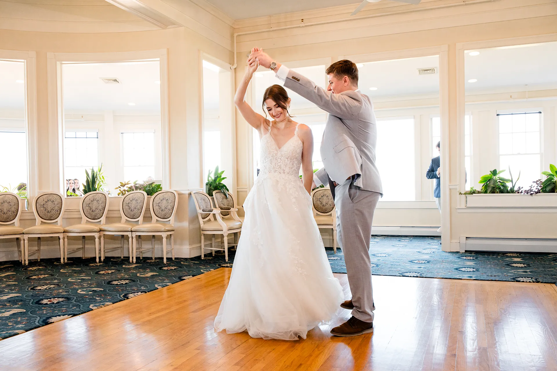 A groom spins a bride while they share a first dance during a wedding reception at the Bar Harbor Inn and Spa in Maine.