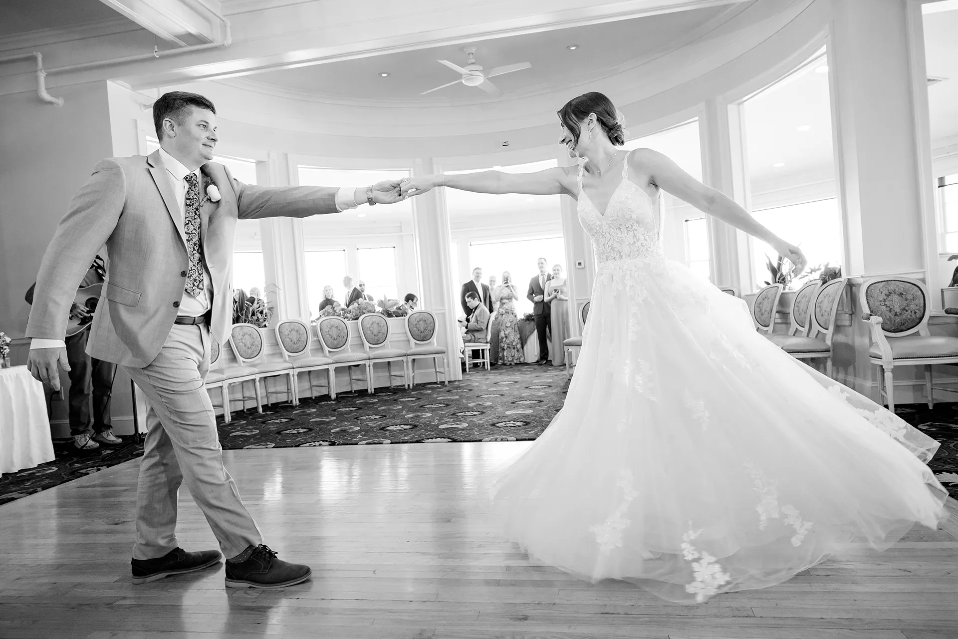 A newly married couple smile as they share a first dance during a wedding reception at the Bar Harbor Inn and Spa near Acadia National Park in Maine.