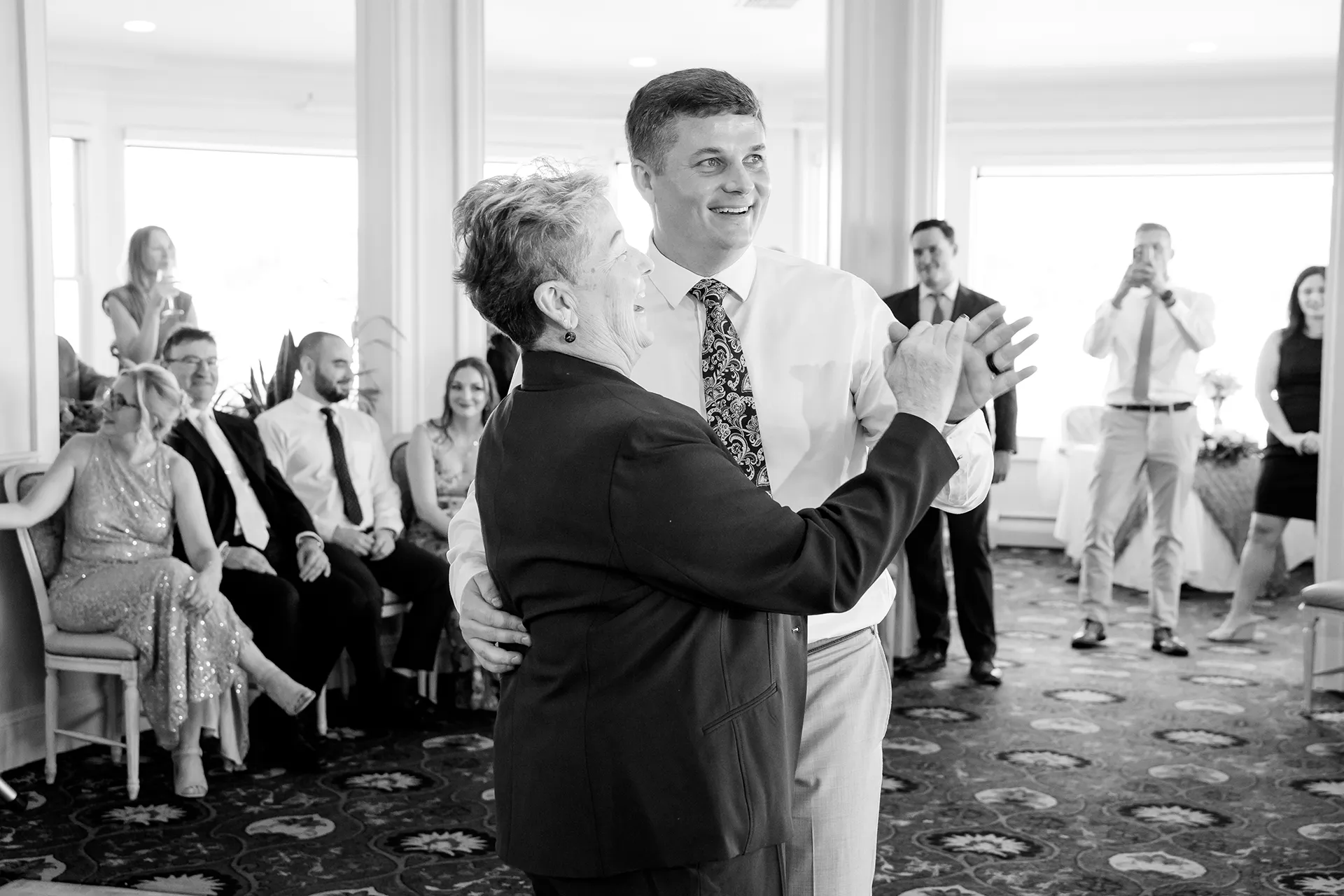 A groom and his mom share a dance during a wedding reception at the Bar Harbor Inn and Spa near Acadia National Park in Maine.