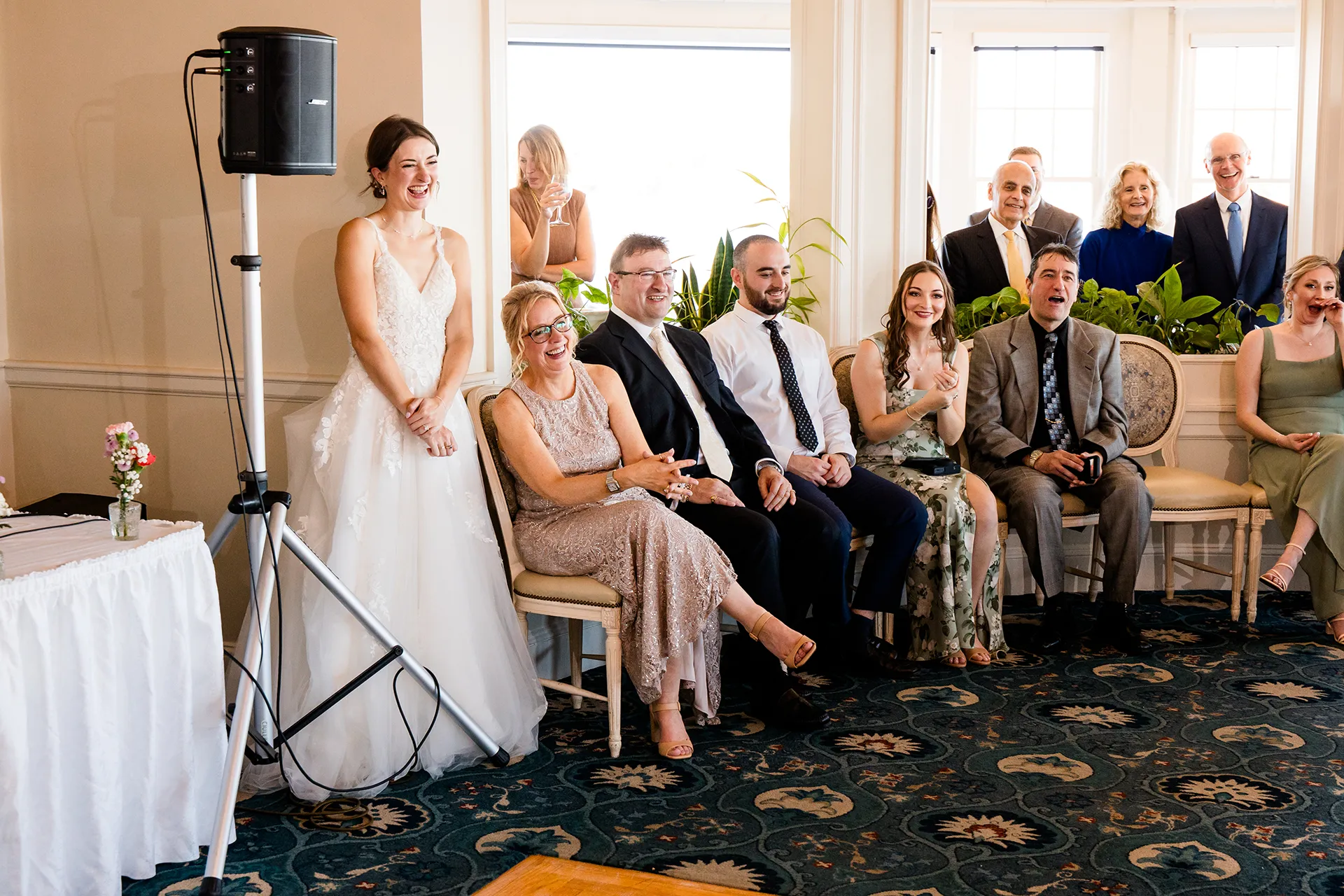 A bride and guests laugh during a wedding reception at the Bar Harbor Inn and Spa near Acadia National Park in Maine.