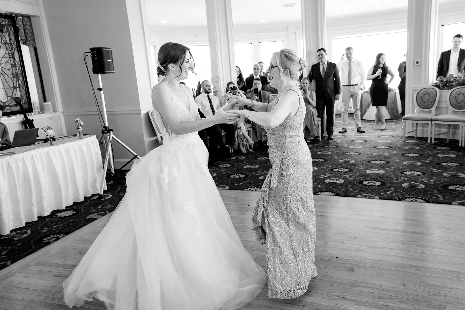 A bride and her mom laugh as they dance during a wedding reception at the Bar Harbor Inn and Spa near Acadia National Park in Maine.