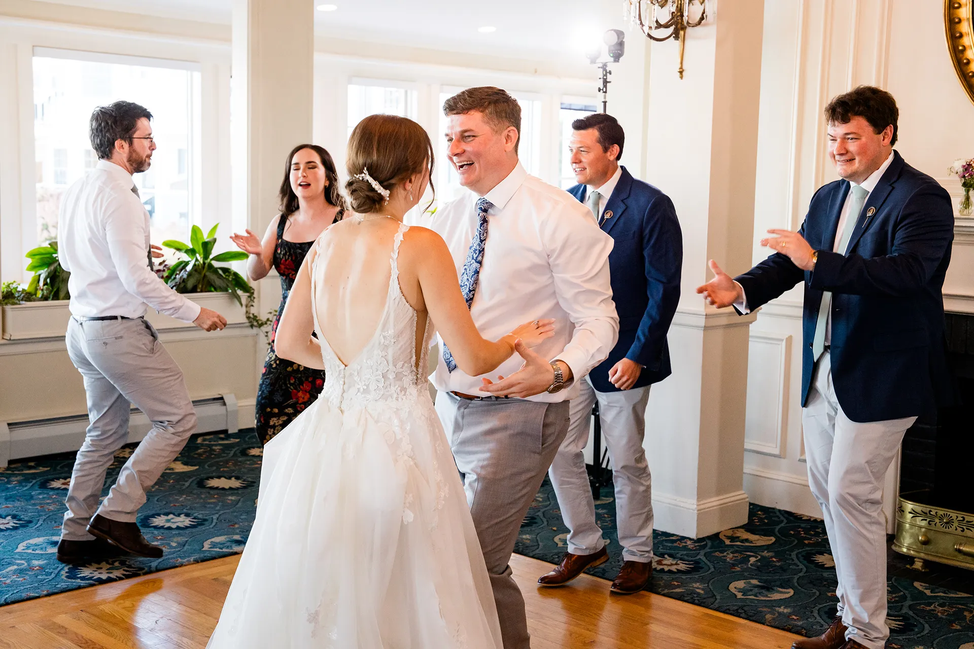 A groom laughs as he dances with a bride during a wedding reception at the Bar Harbor Inn and Spa near Acadia National Park in Maine.