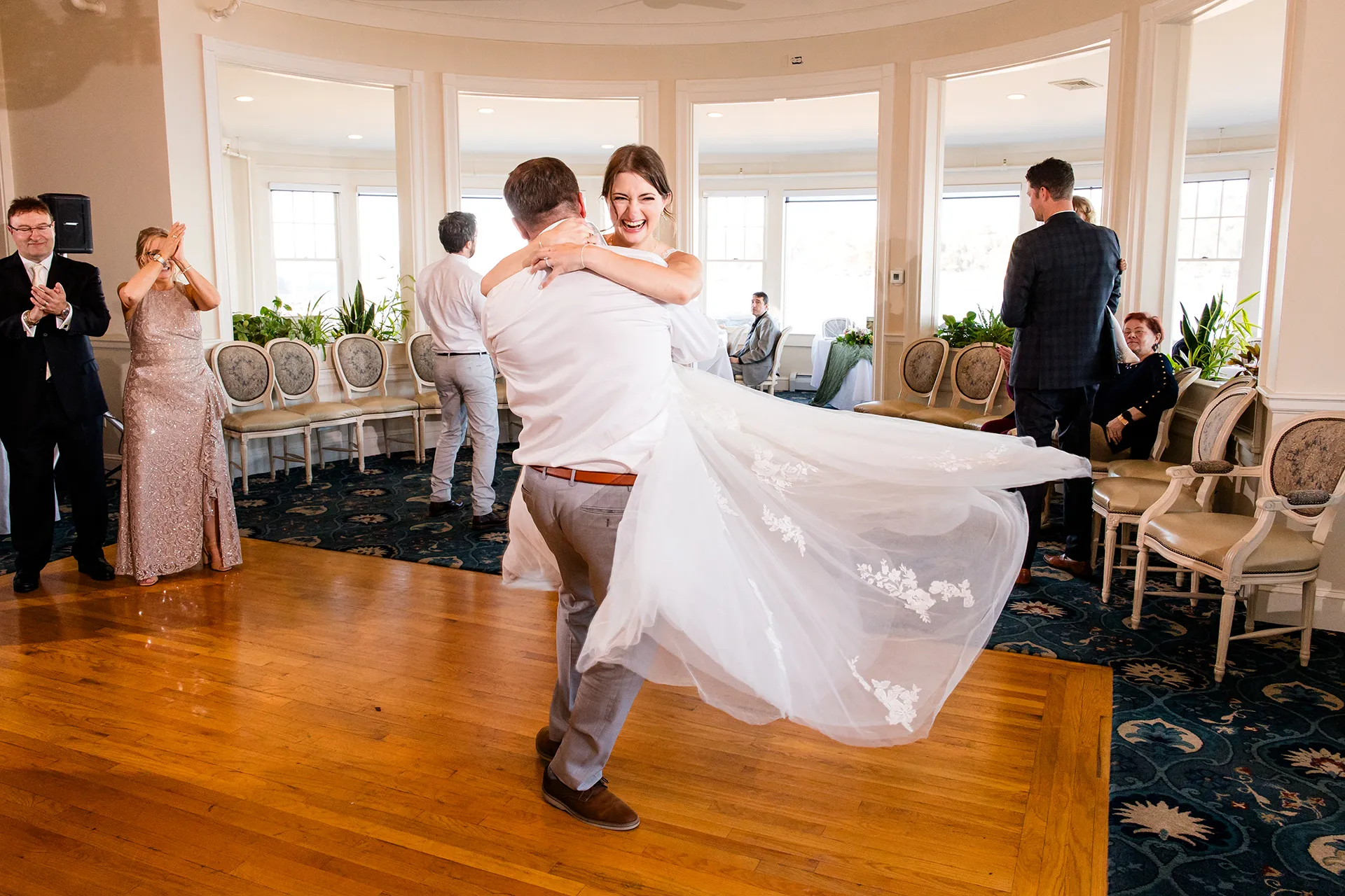 A groom picks up a bride and spins her during a wedding reception at the Bar Harbor Inn and Spa near Acadia National Park in Maine.