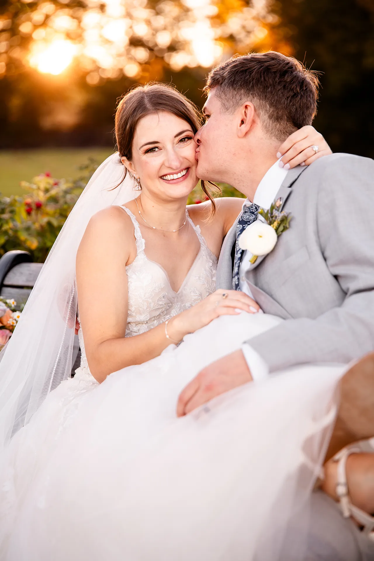 A groom kisses a bride on the cheek during wedding portraits on the property of the Bar Harbor Inn and Spa near the Acadia National Park in Maine.
