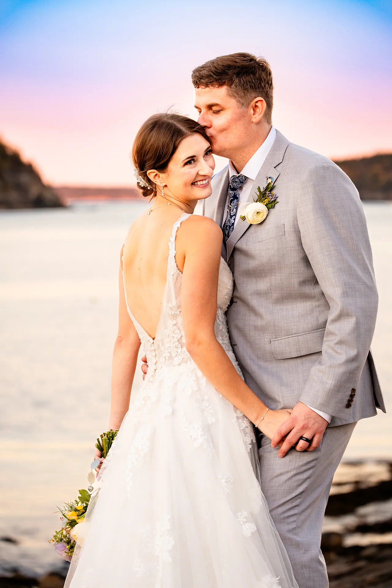 A newly married couple hold hands while the groom kissed the bride on the cheek at the Bar Harbor Inn and Spa near the Acadia National Park in Maine.