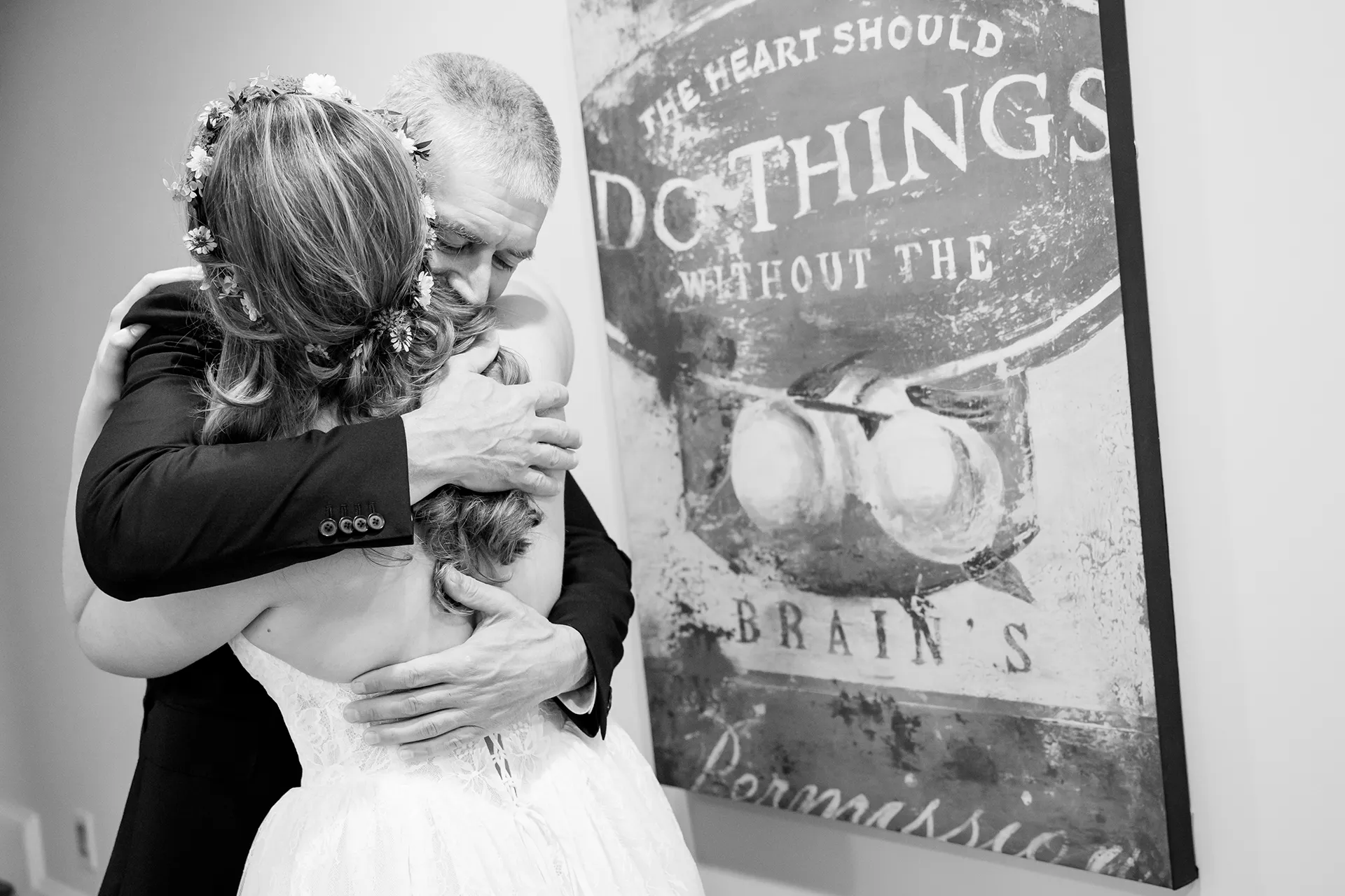 A dad hugs a bride after seeing her for the first time before her wedding in Bangor, Maine.