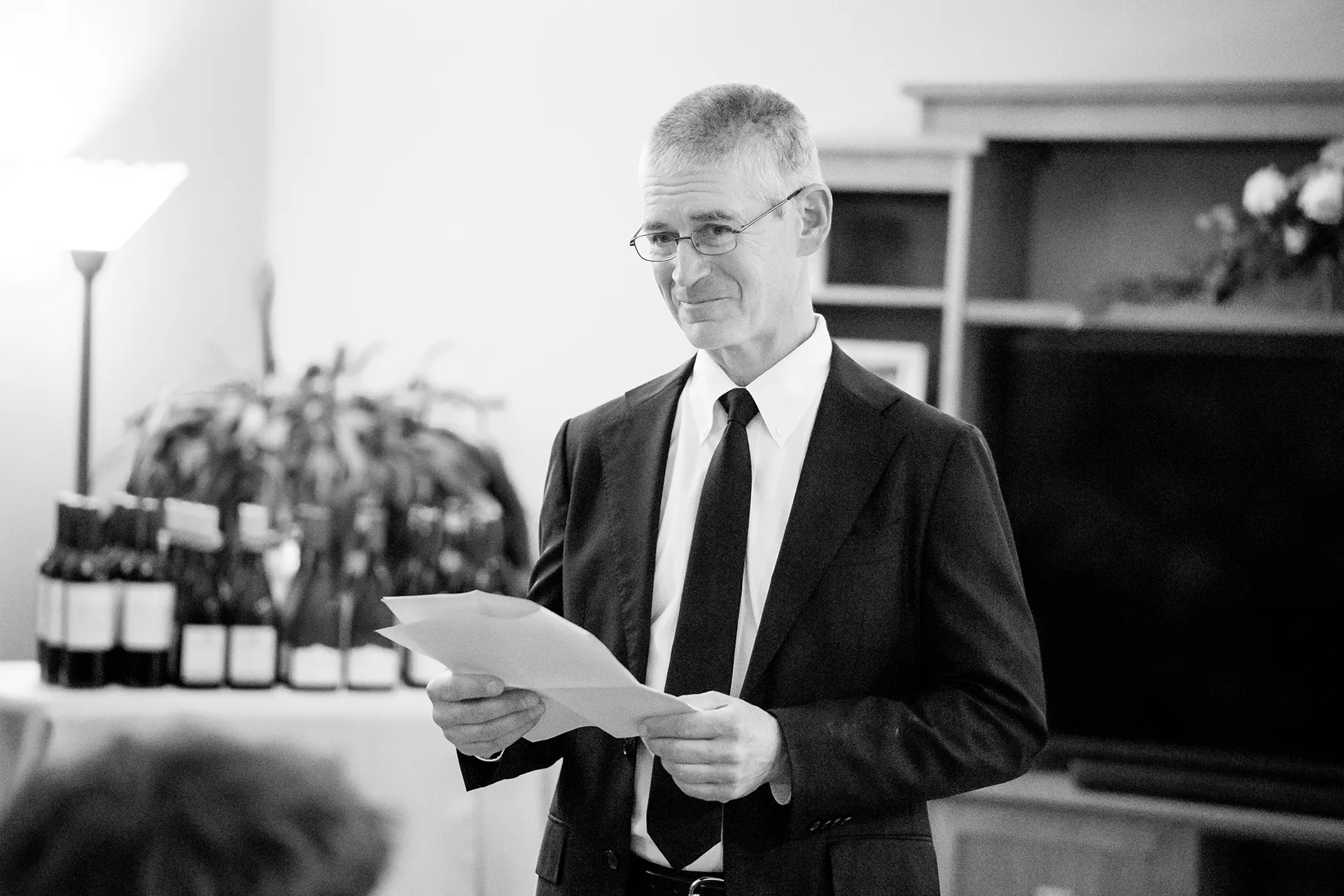 A dad smiles as he gives a toast during a micro wedding reception at a private residence in Bangor, Maine.