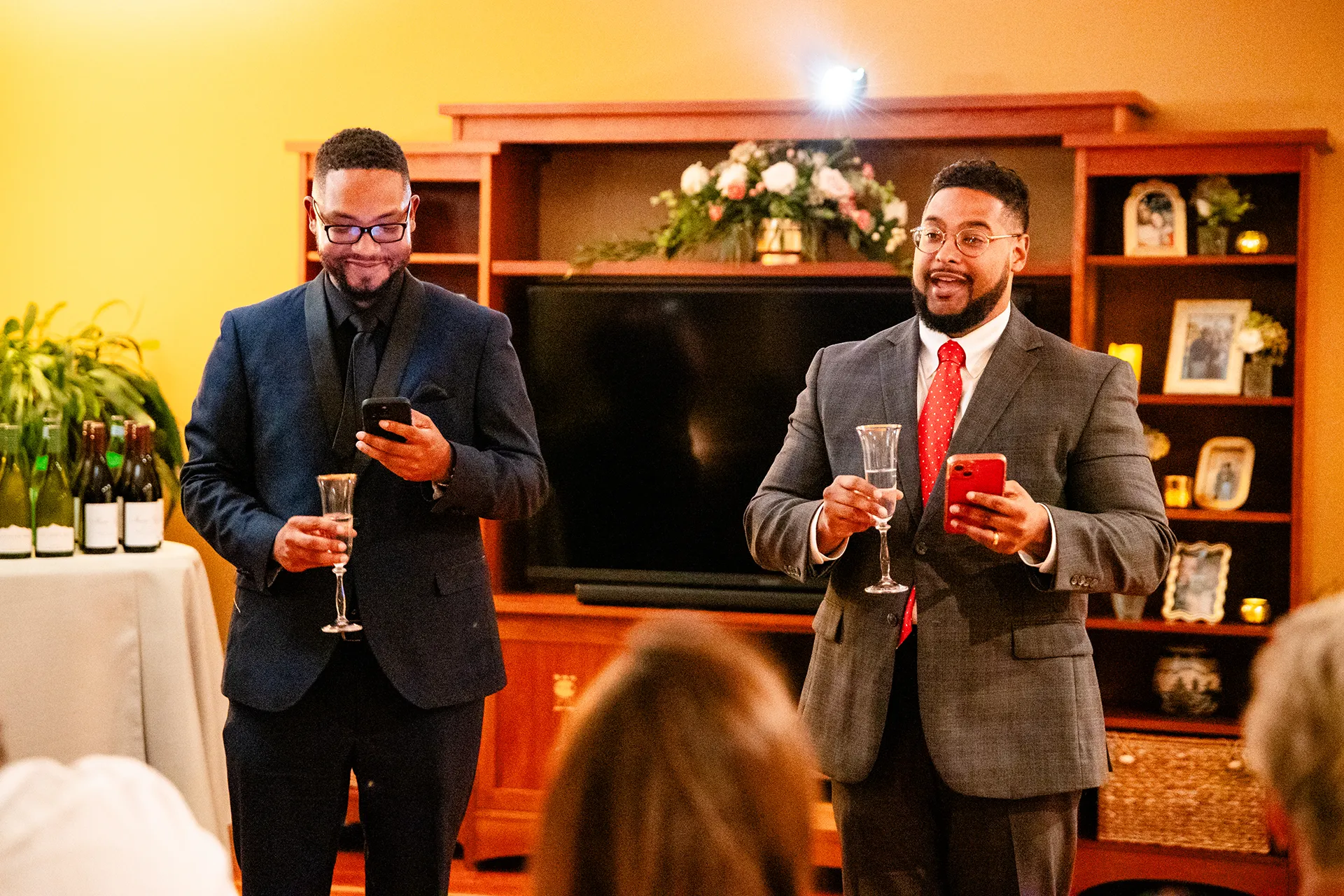 Two men give a toast during a micro wedding reception at a private residence in Bangor, Maine.