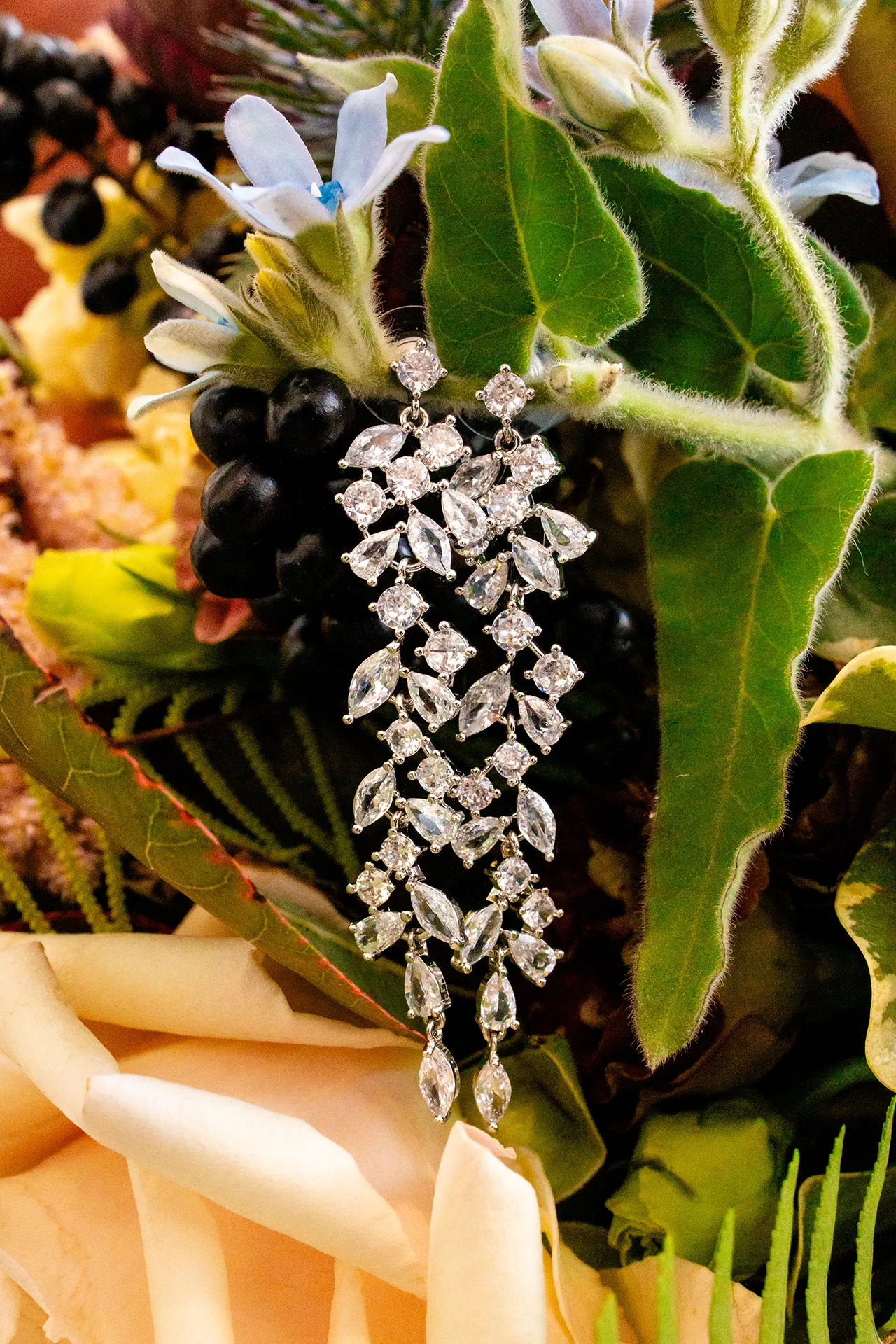 A pair of earrings hang from a bouquet of flowers at the Bar Harbor Club near Acadia National Park in Maine.