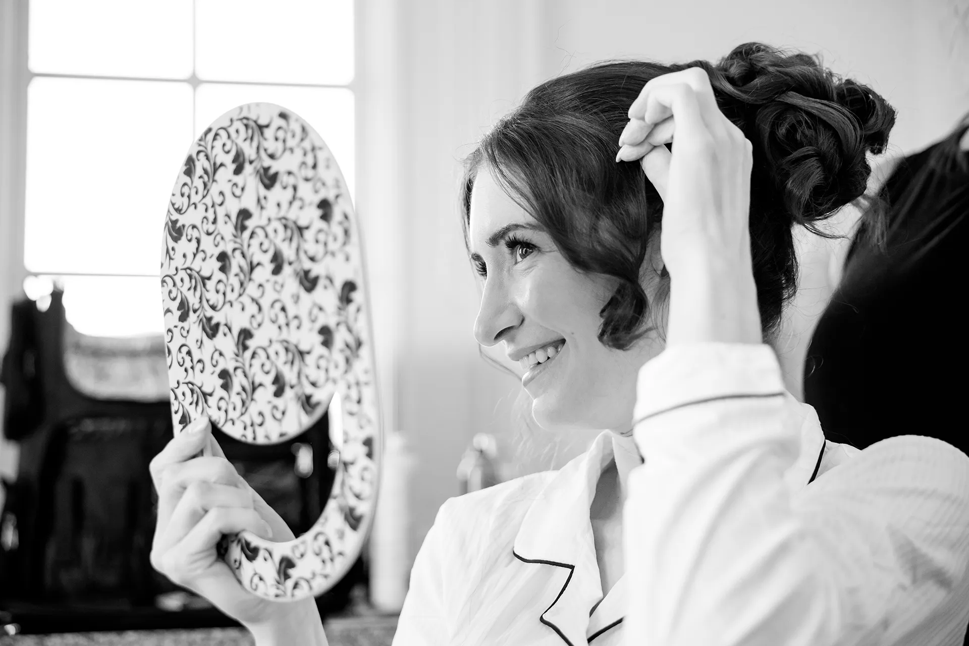 A bride smiles as she gets ready for a wedding at the Bar Harbor Club near Acadia National Park in Maine.