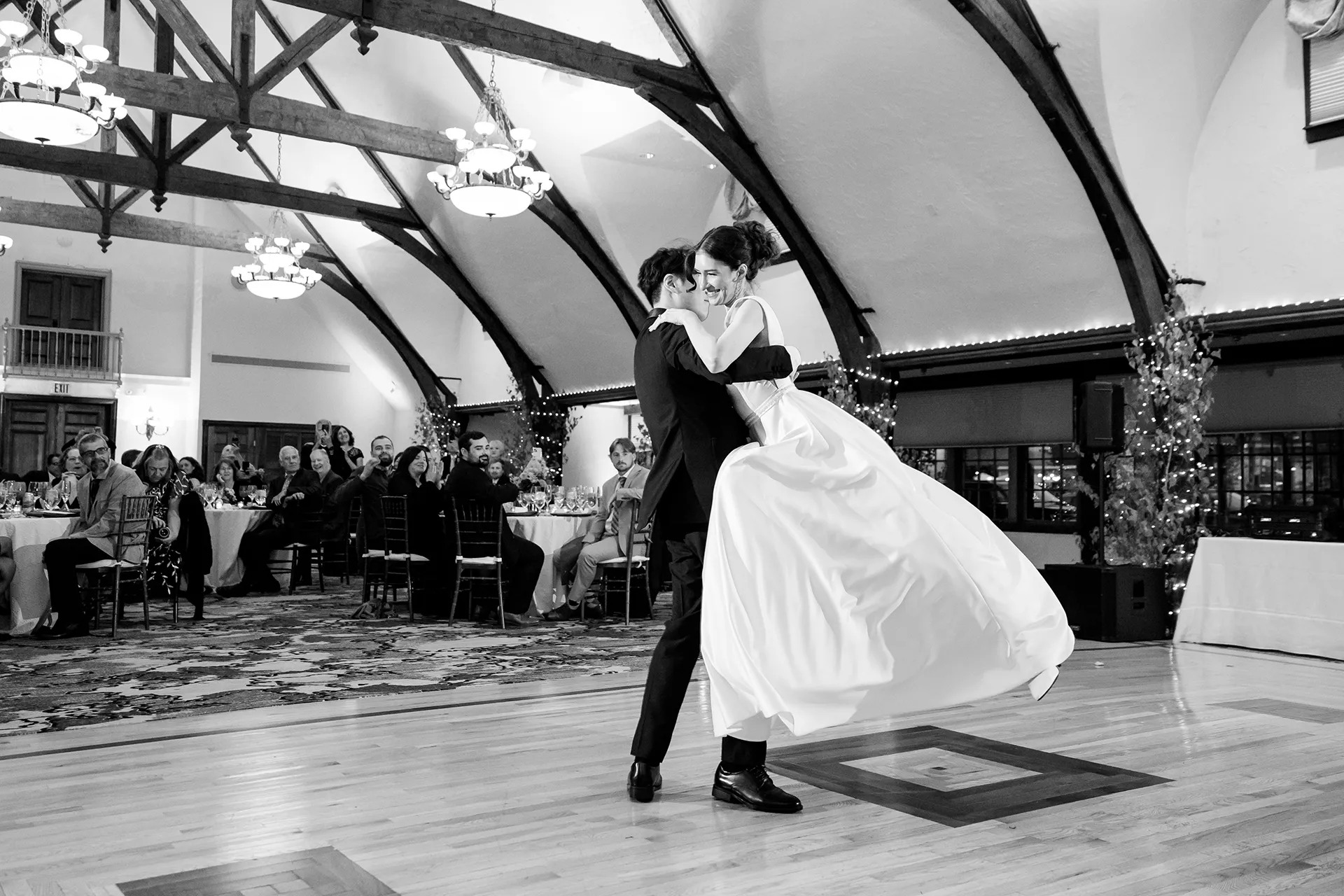 A groom spins a bride as they share a first dance during a wedding reception at the Bar Harbor Club in Maine.