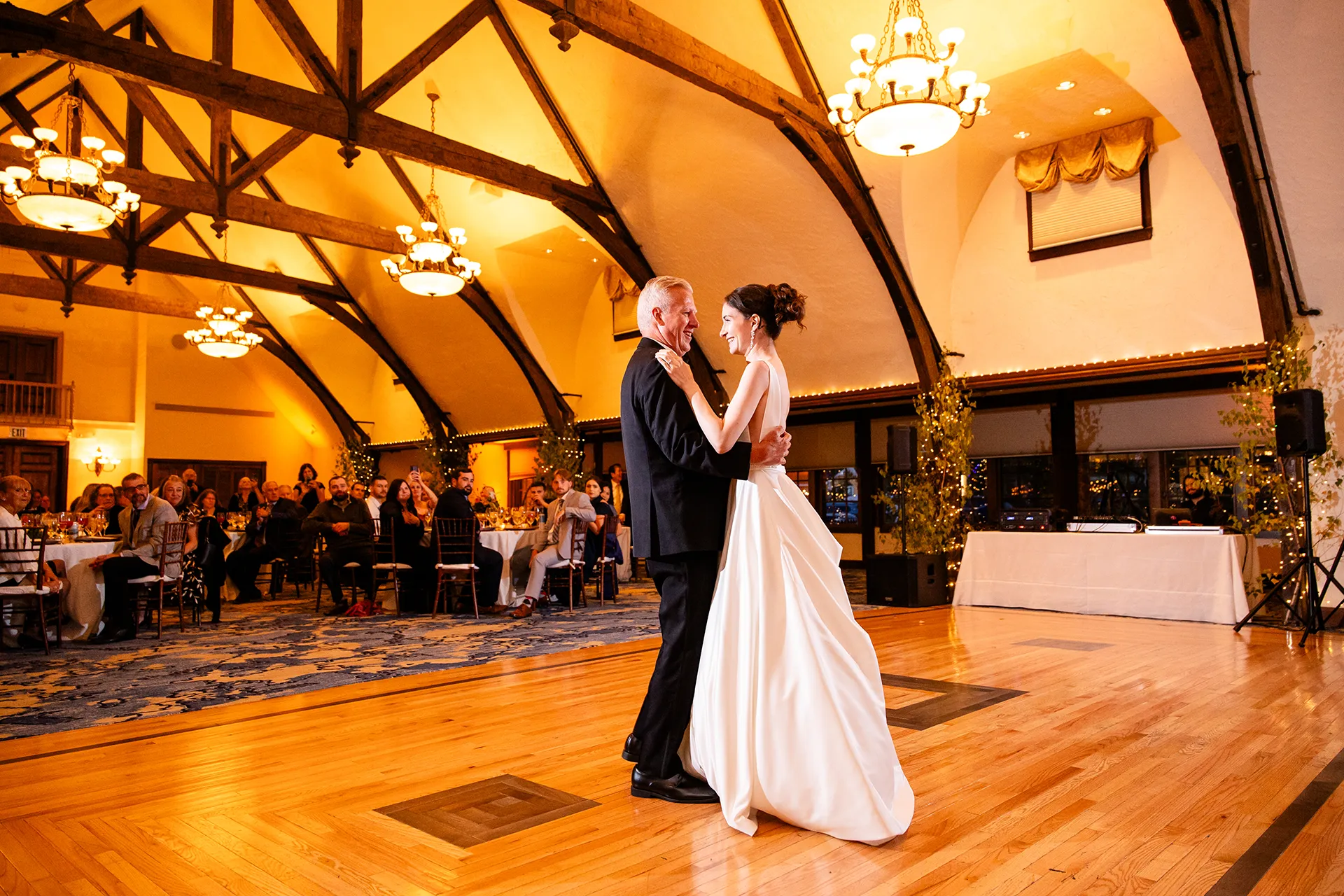 A bride and her dad smile at each other while they dance during a wedding reception at the Bar Harbor Club in Maine.