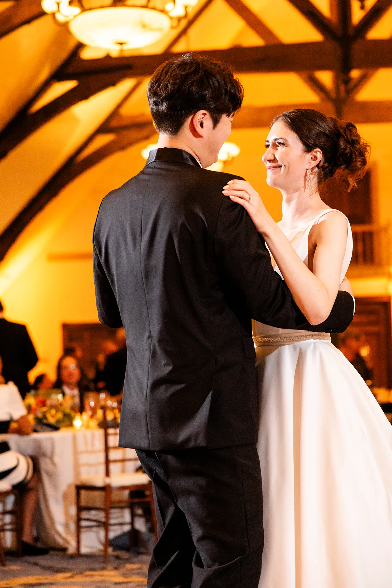 A bride smiles at a groom as they share a first dance during a wedding reception at the Bar Harbor Club in Maine.