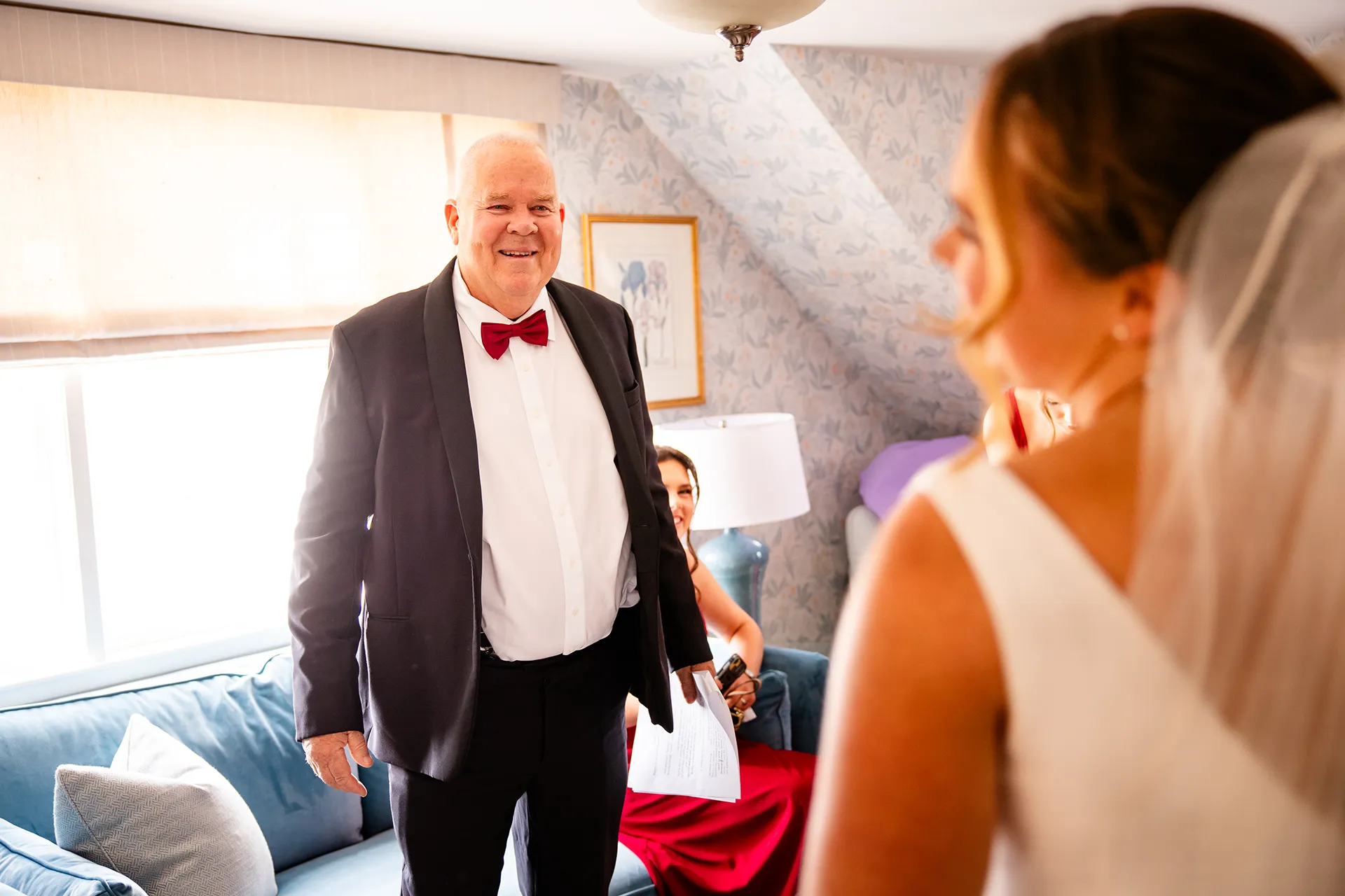 A dad smiles as he sees a bride for the first time at Fruitlands Museum in Harvard Massachusetts.