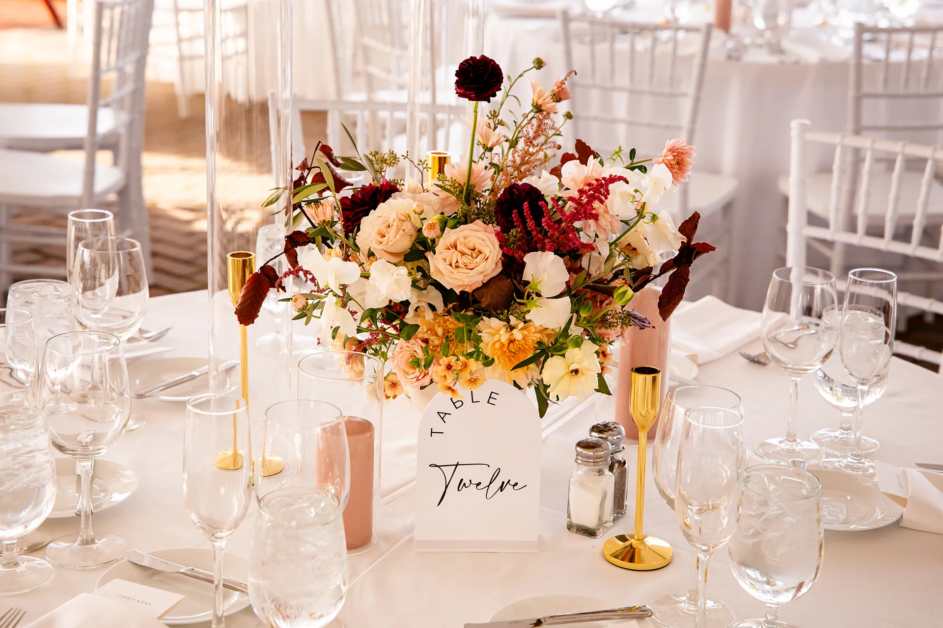 A closeup of a floral centerpiece for a wedding reception at Fruitlands Museum in Harvard, Massachusetts.