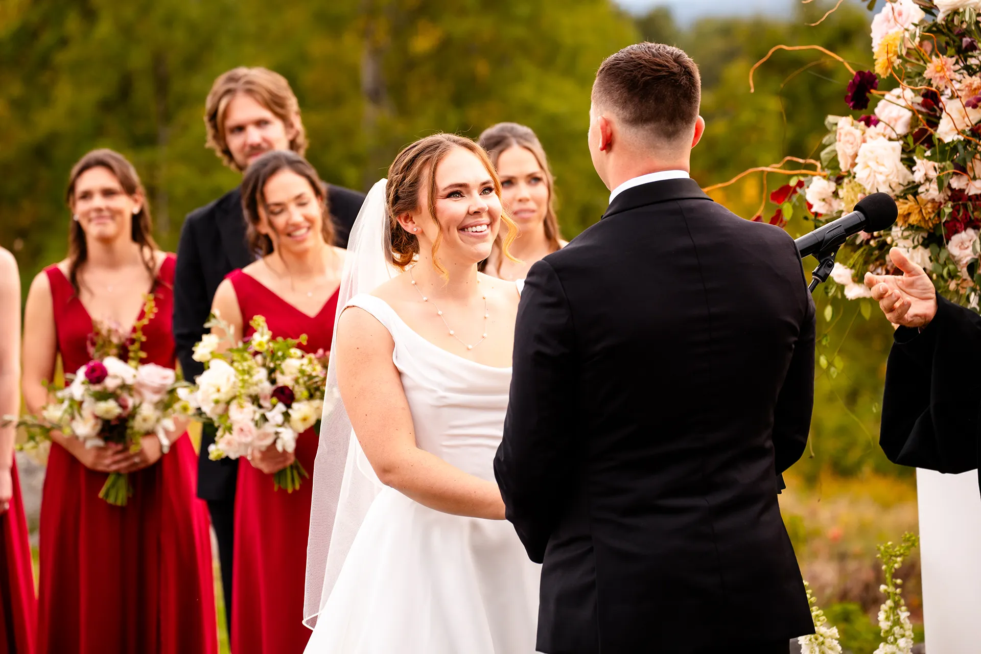 A bride smiles at a groom during a wedding ceremony at Fruitlands Museum in Harvard Massachusetts.