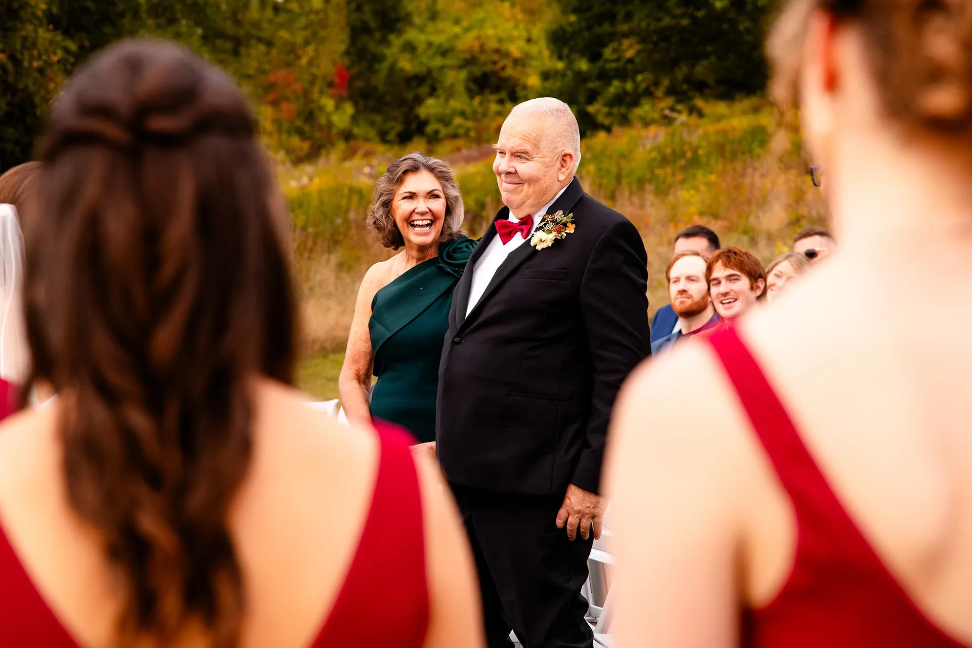 Parents laugh as they stand during a wedding ceremony at Fruitlands Museum in Harvard Massachusetts.