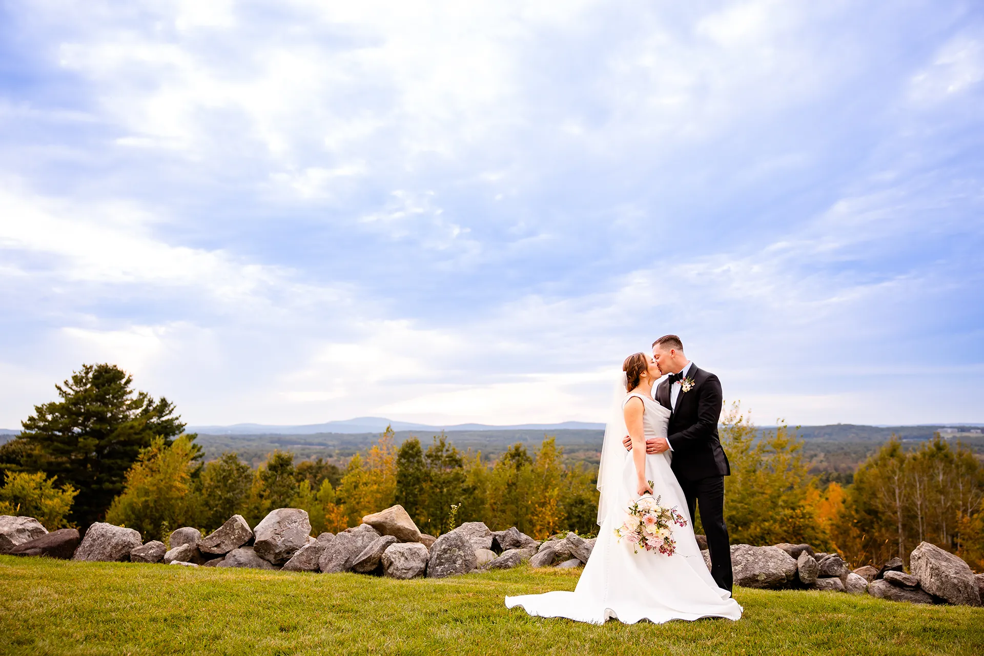 A bride and groom kiss during wedding portraits at Fruitlands Museum in Harvard, Massachusetts.