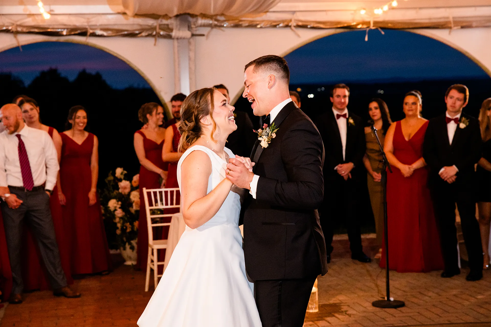 A bride and groom laugh as they share a first dance during a wedding reception at Fruitlands Museum in Harvard, Massachusetts.