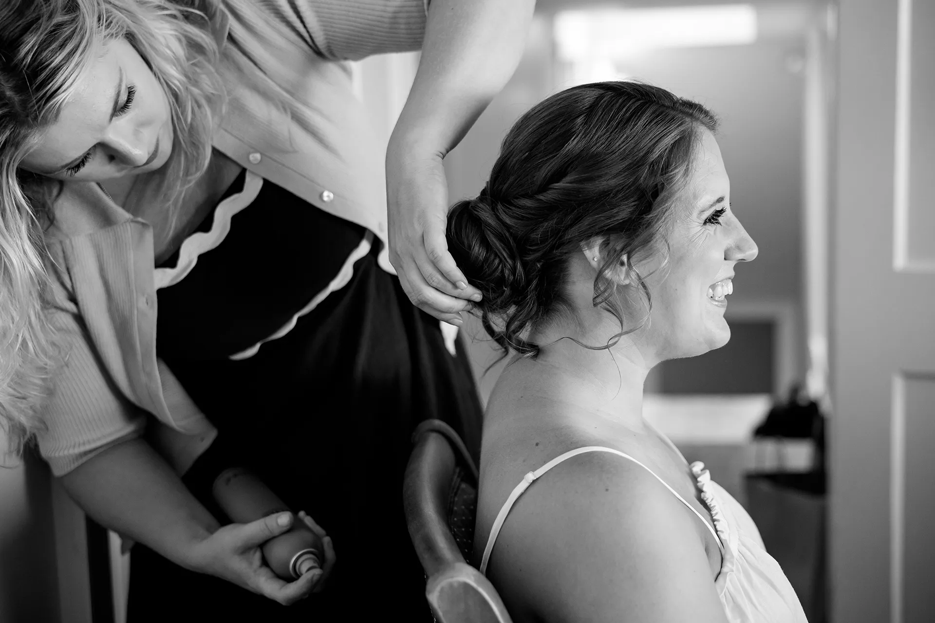 maine wedding photography meghan phil 07 A bride smiles as she gets her hair done for her wedding at the Atlantic Oceanside Hotel and Event Center in Bar Harbor, Maine.