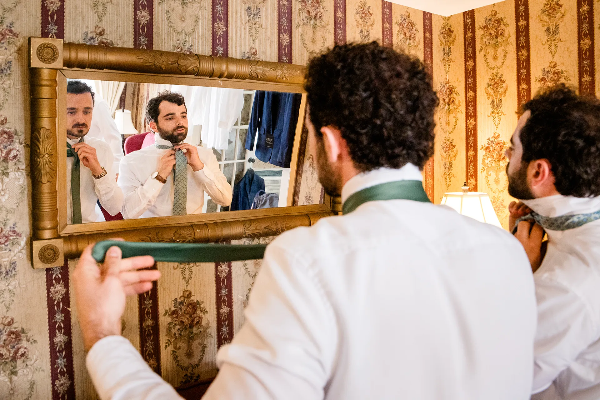 maine wedding photography meghan phil 15 A groom and groomsman put on their ties as they get ready for a wedding at the Atlantic Oceanside Hotel and Event Center in Bar Harbor, Maine.