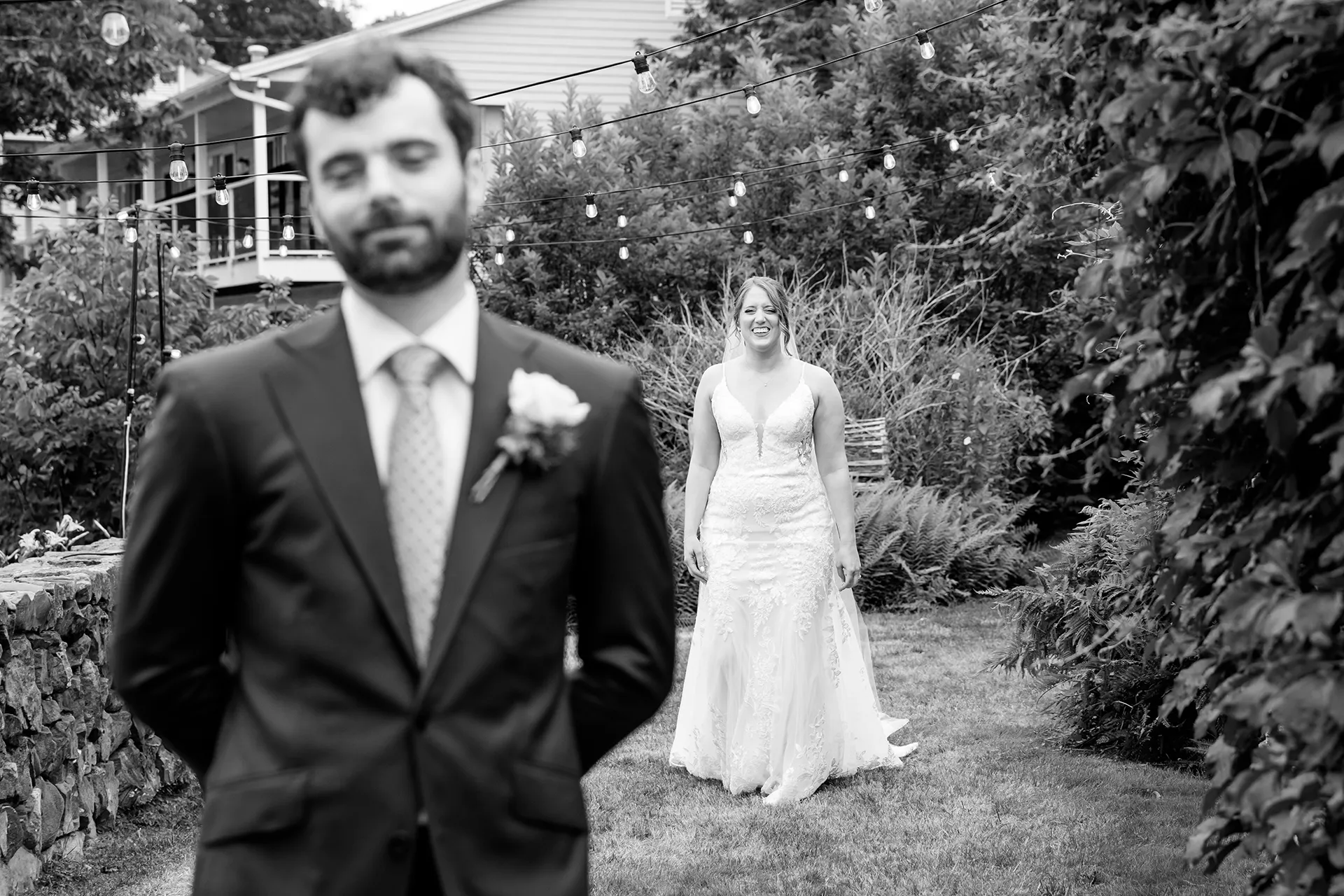 maine wedding photography meghan phil 20 A bride walks towards a groom during a first look at the Atlantic Oceanside Hotel & Event Center in Bar Harbor, Maine.