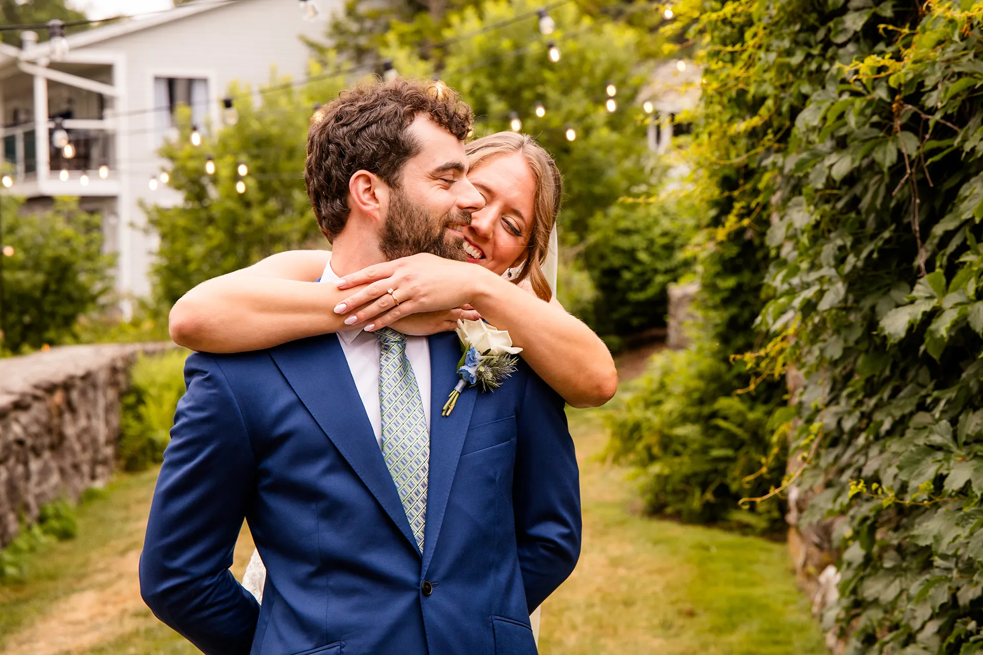 maine wedding photography meghan phil 21 A bride hugs a groom during a first look in the garden at the Atlantic Oceanside Hotel & Event Center in Bar Harbor, Maine.