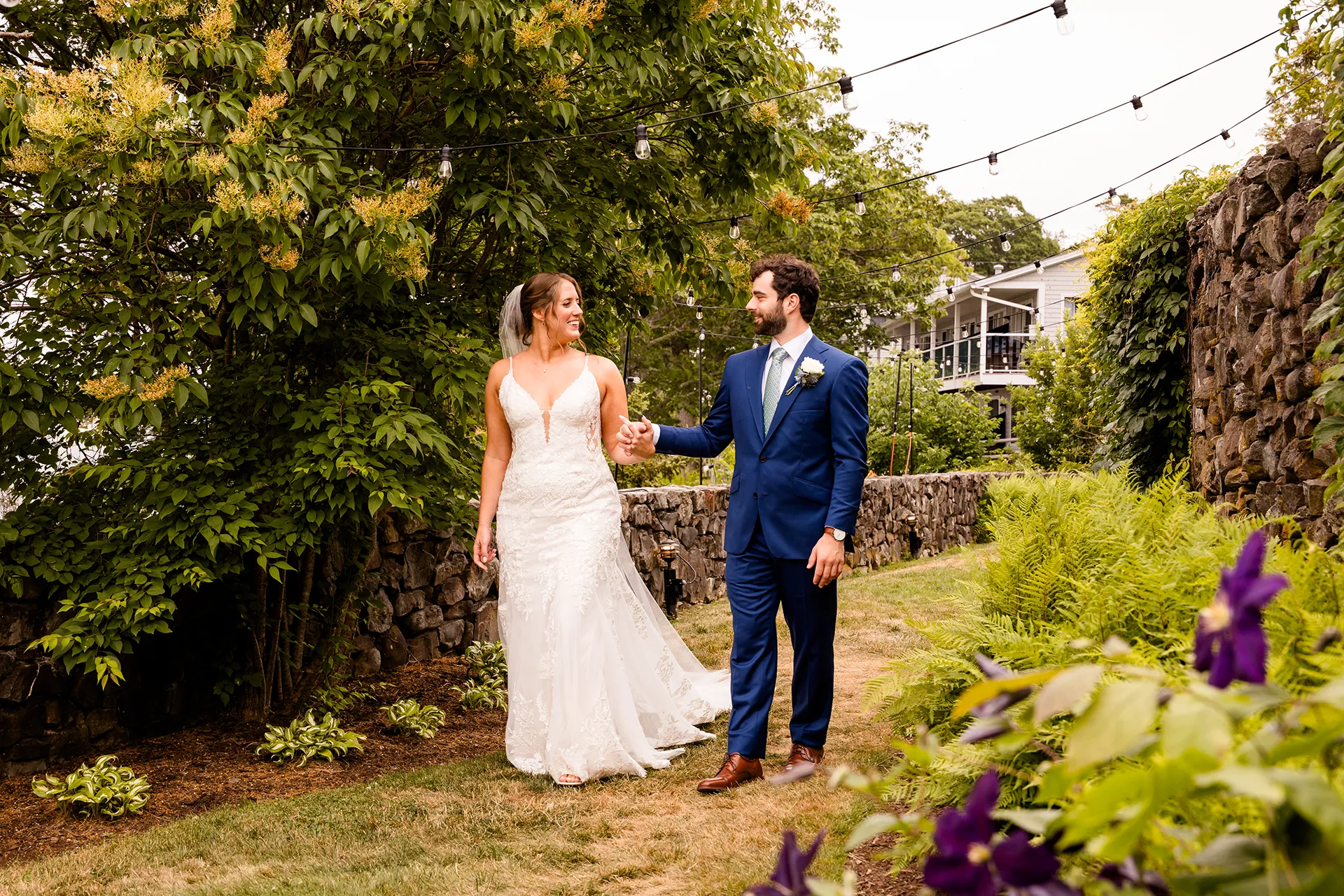 maine wedding photography meghan phil 23 A bride and groom hold hands and walk in the garden at the Atlantic Oceanside Hotel & Event Center in Bar Harbor, Maine.
