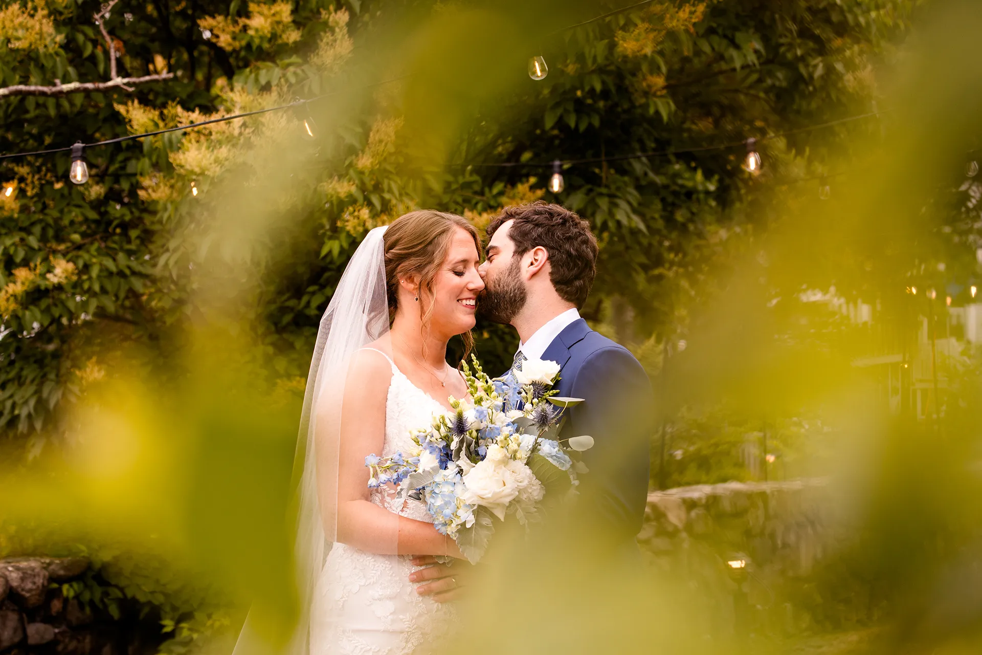 maine wedding photography meghan phil 25 A groom kisses a bride on the cheek during wedding portraits at the Atlantic Oceanside Hotel & Event Center in Bar Harbor, Maine.