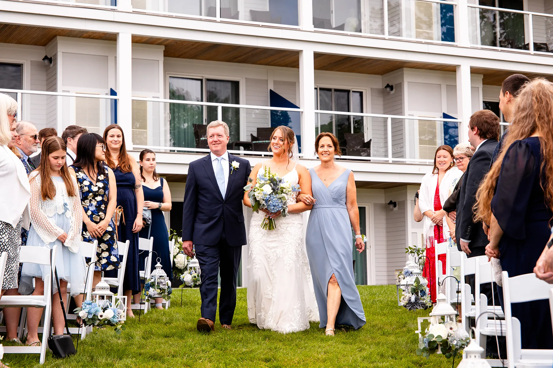 maine wedding photography meghan phil 31 A bride and her parents walk down the aisle during a wedding ceremony at the Atlantic Oceanside Hotel & Event Center in Bar Harbor, Maine.