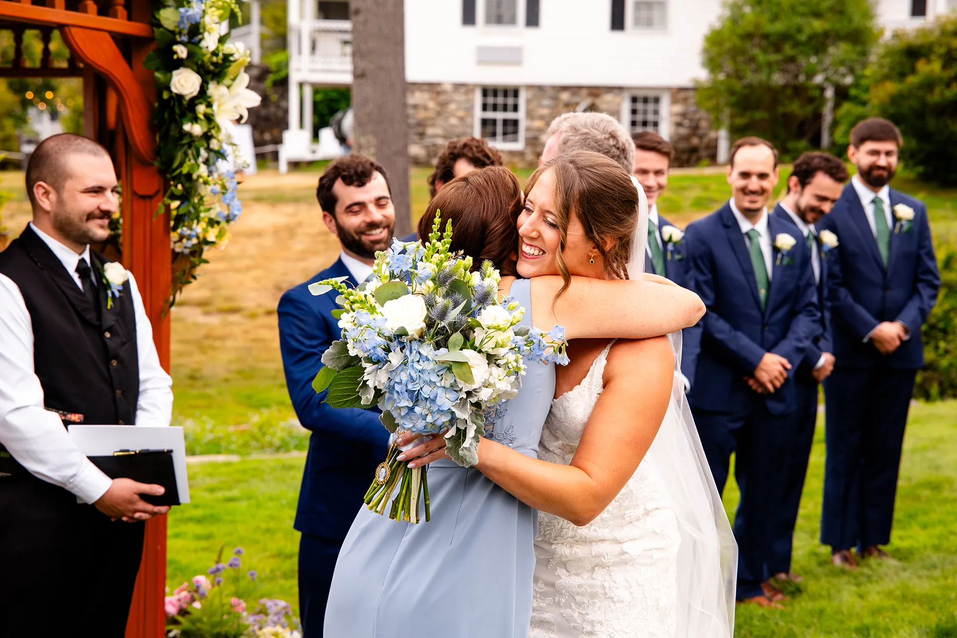 maine wedding photography meghan phil 32 A bride hugs her mom during a wedding ceremony at the Atlantic Oceanside Hotel & Event Center in Bar Harbor, Maine.