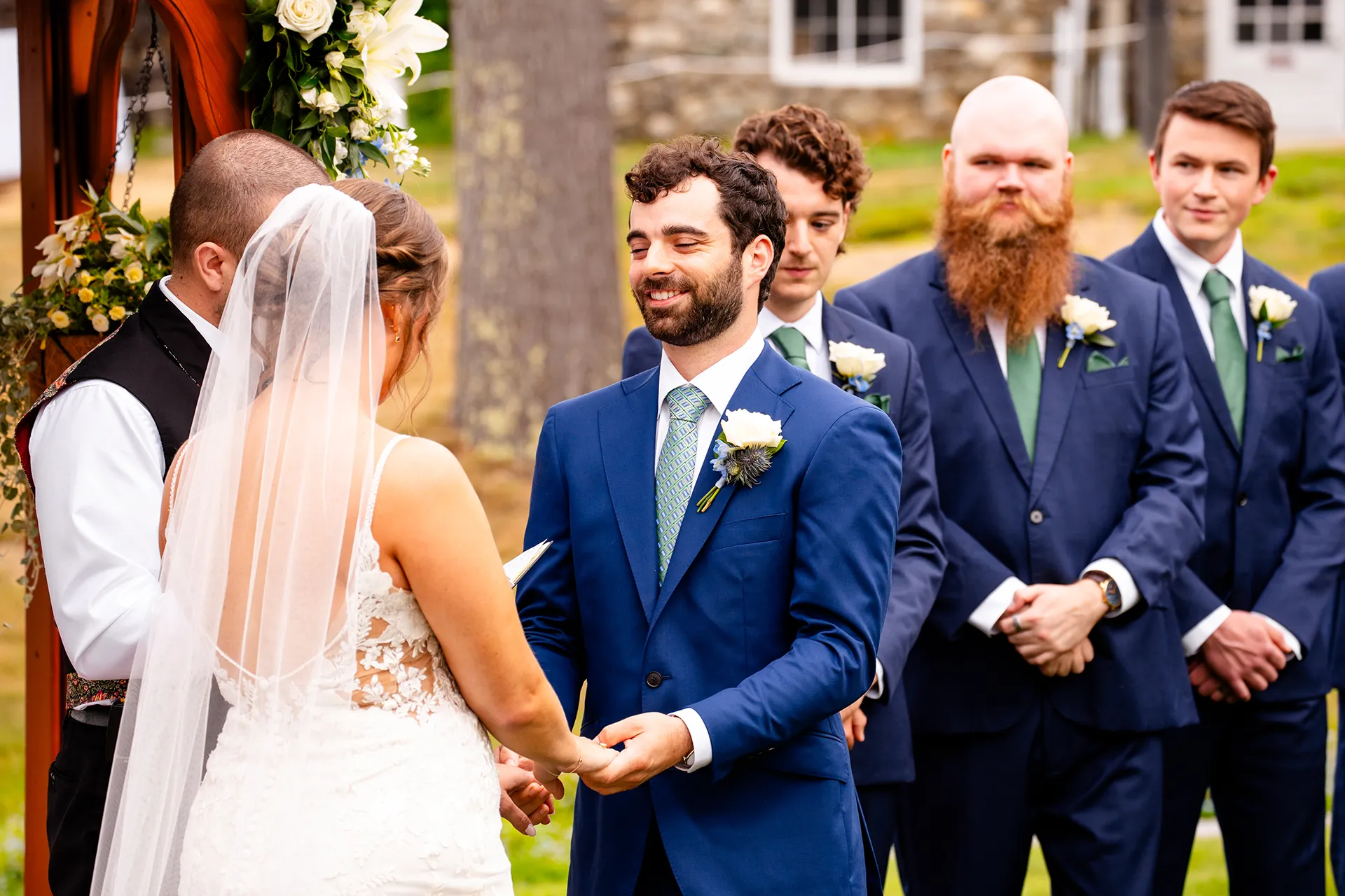 maine wedding photography meghan phil 34 A grooms smiles as he holds a bride's hands during a wedding ceremony at the Atlantic Oceanside Hotel & Event Center in Bar Harbor, Maine.