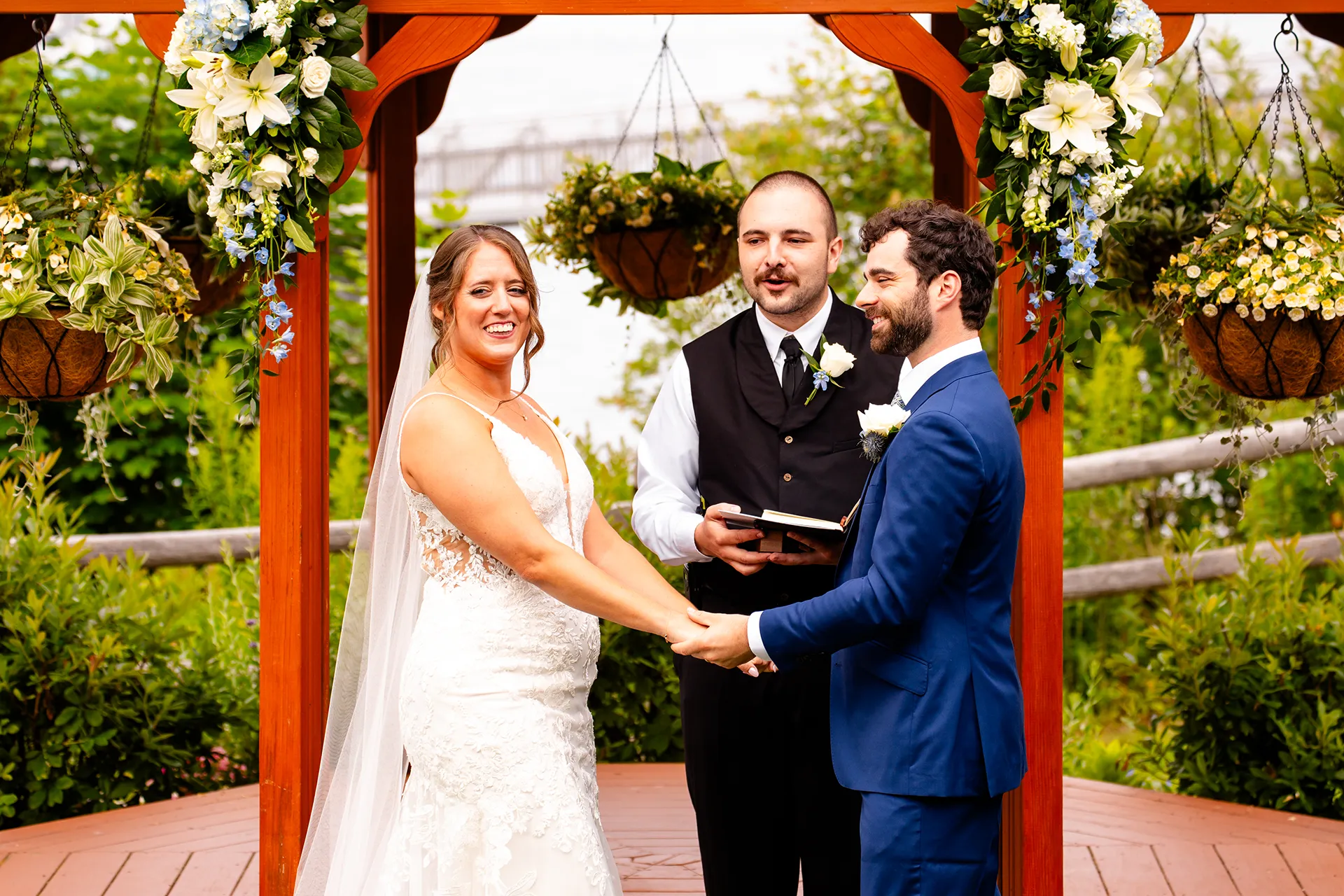 maine wedding photography meghan phil 38 A bride and groom laugh as holding hands during a wedding ceremony at the Atlantic Oceanside Hotel & Event Center in Bar Harbor, Maine.