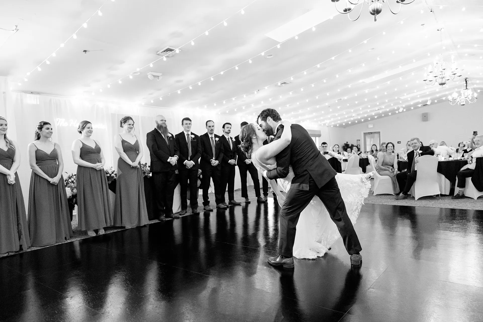 maine wedding photography meghan phil 43 A groom dips a bride as guests watch during a wedding reception at the Atlantic Oceanside Hotel & Event Center in Bar Harbor, Maine.