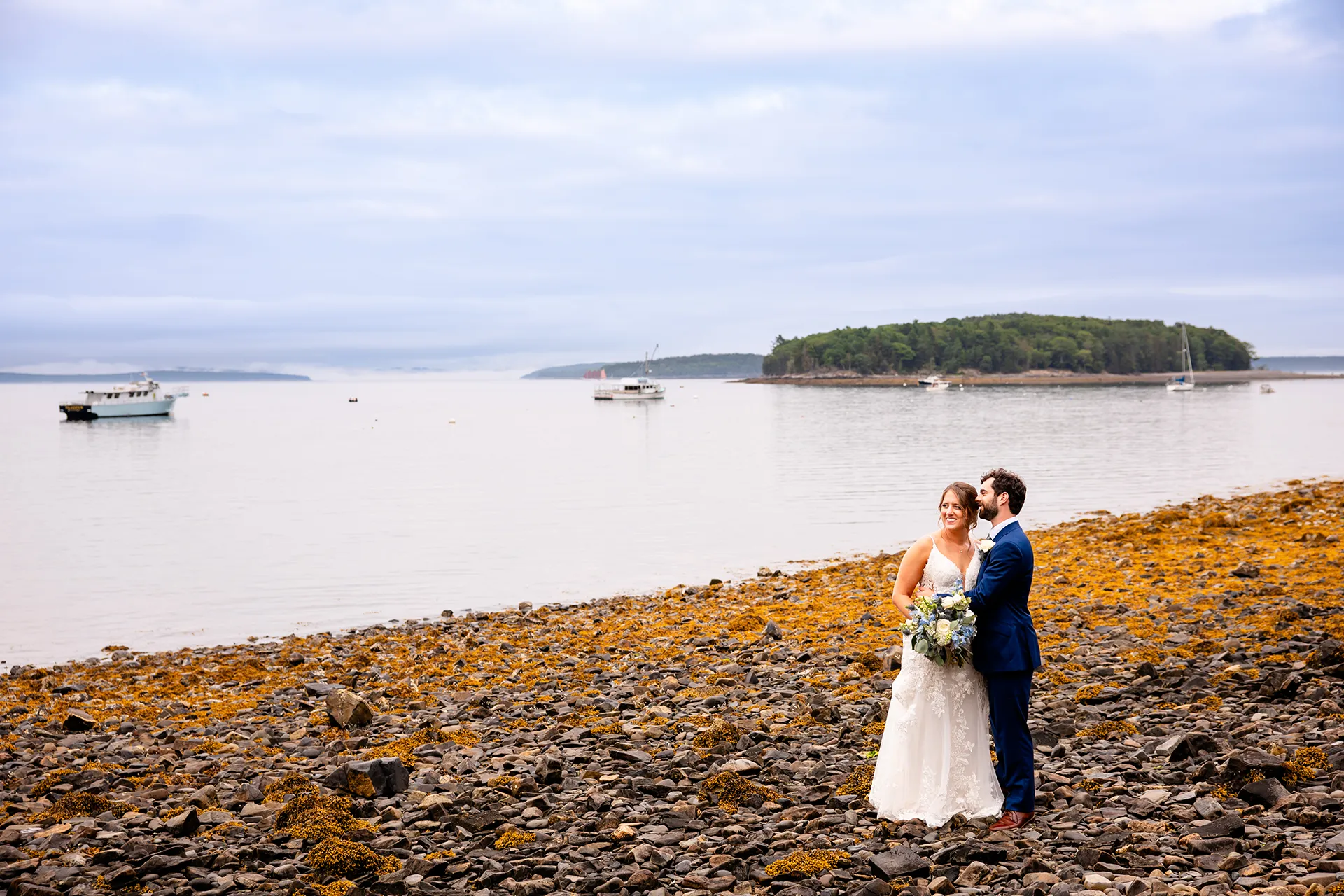 maine wedding photography meghan phil 49 A groom snuggles into a bride during beach wedding portraits at the Atlantic Oceanside Hotel & Event Center in Bar Harbor, Maine.