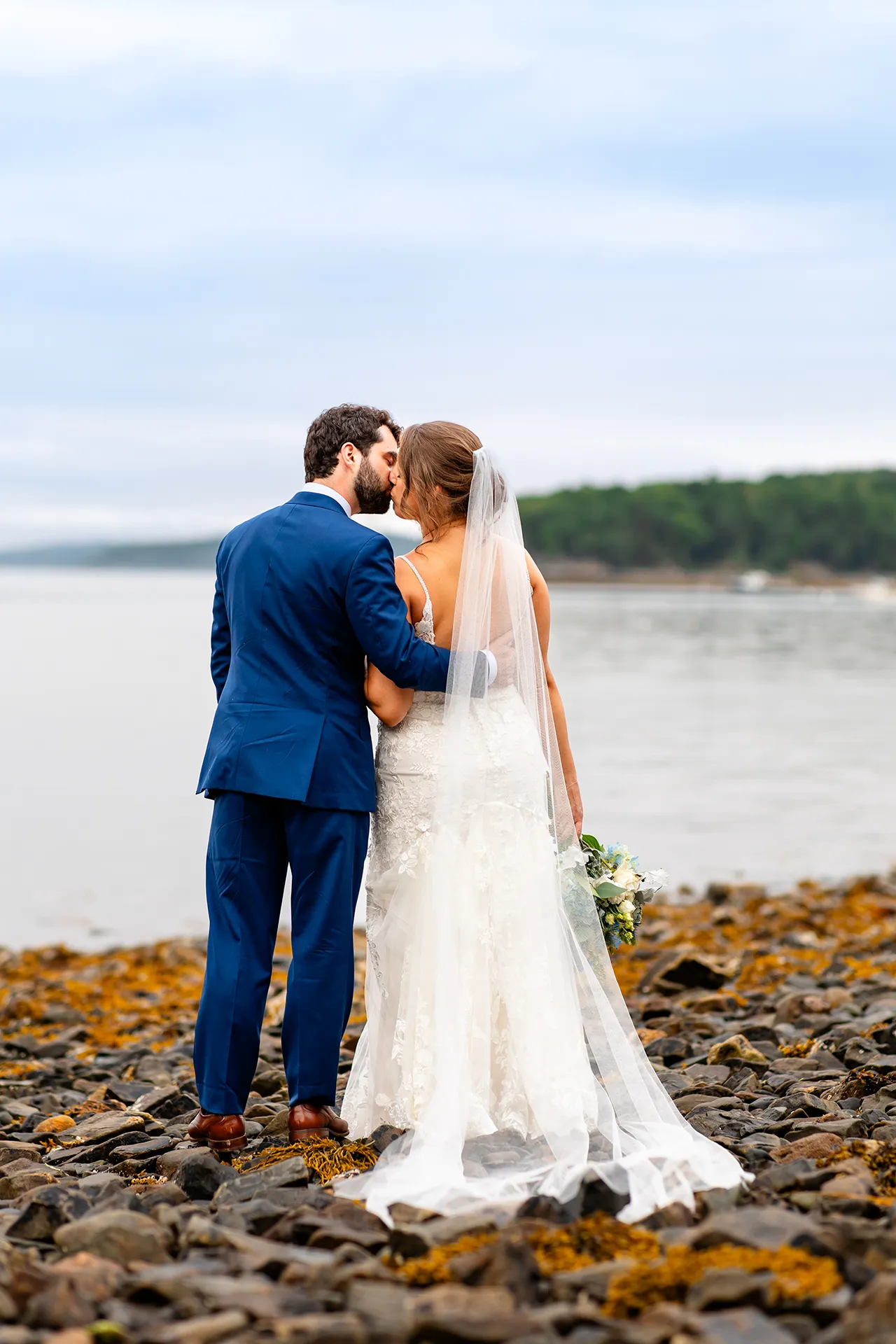 maine wedding photography meghan phil 52 A bride and groom kiss during beach wedding portraits at the Atlantic Oceanside Hotel & Event Center in Bar Harbor, Maine.