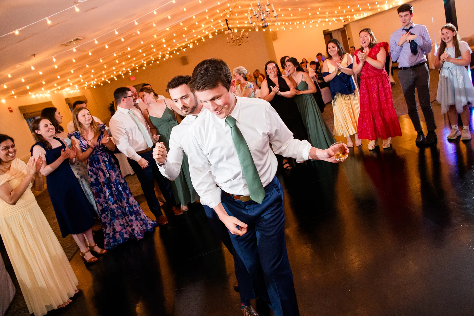 maine wedding photography meghan phil 56 A groomsman dances during a wedding reception at the Atlantic Oceanside Hotel & Event Center in Bar Harbor, Maine.