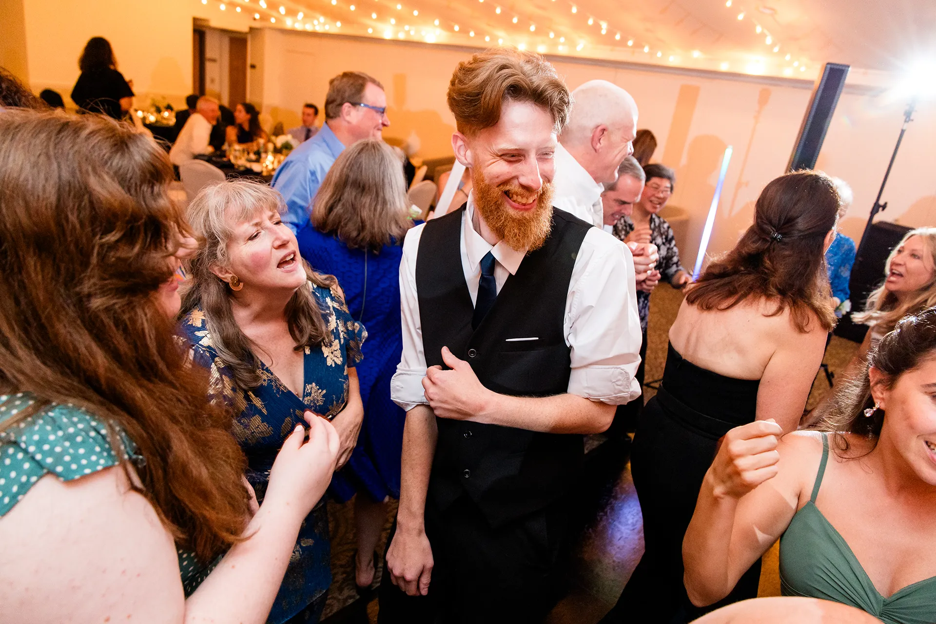 maine wedding photography meghan phil 60 A man smiles as he dances during a wedding reception at the Atlantic Oceanside Hotel & Event Center in Bar Harbor, Maine.
