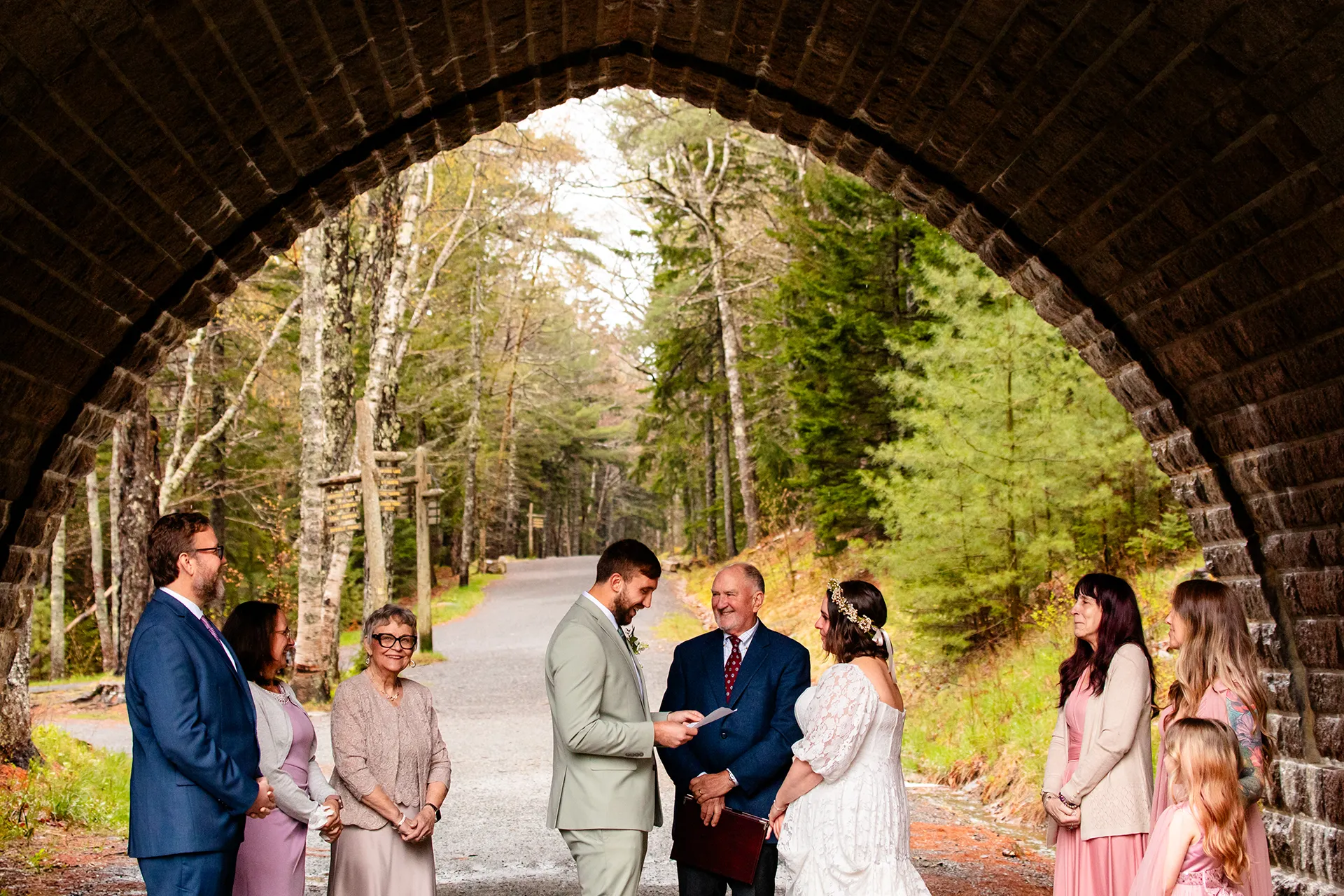 maine wedding photography mystic andrew 05 A groom reads his vows to a bride during a wedding ceremony under a bridge at Eagle Lake in Acadia National Park near Bar Harbor, Maine.