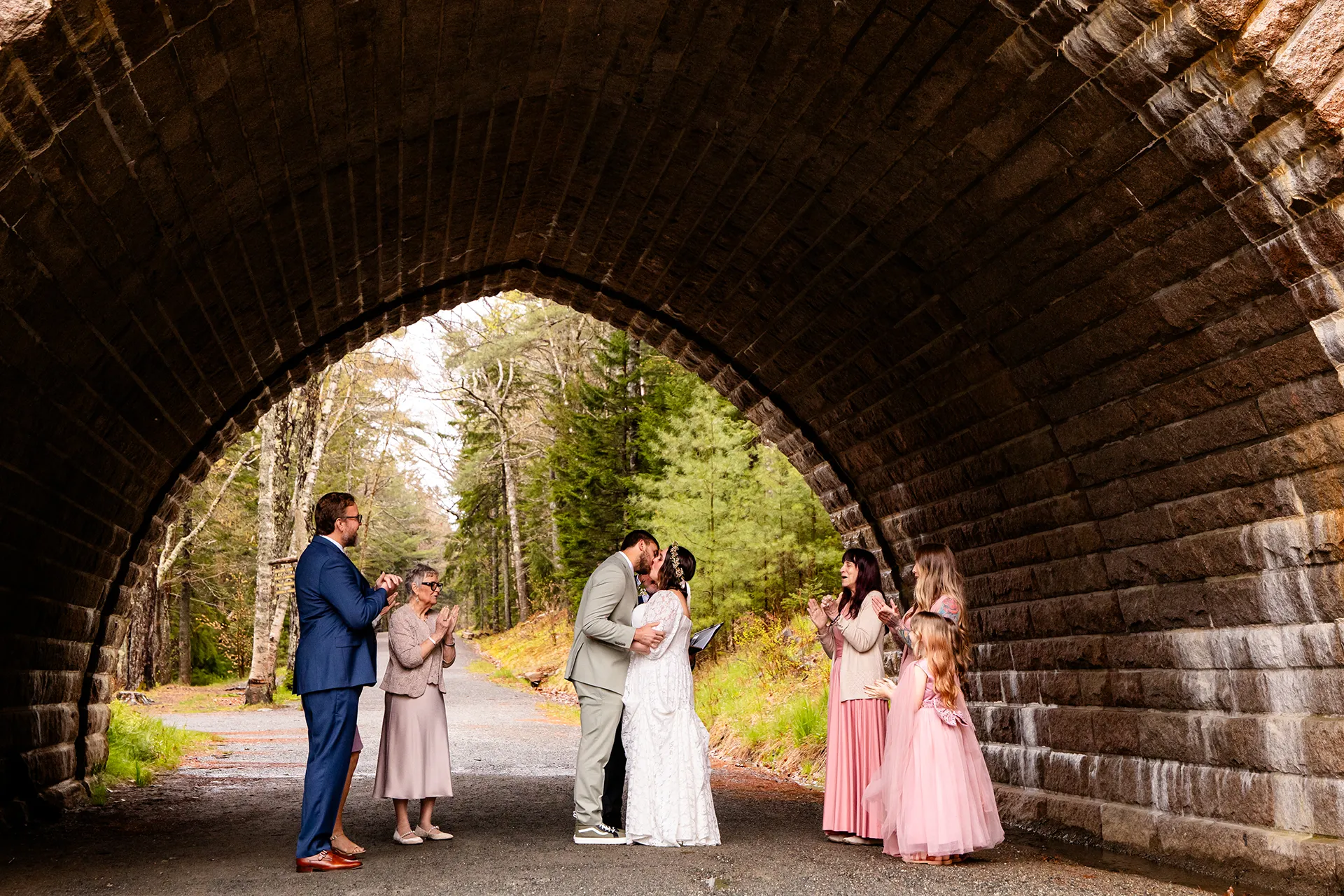 maine wedding photography mystic andrew 06 A bride and groom kiss after getting married under a stone bridge at Eagle Lake in Acadia National Park near Bar Harbor, Maine.