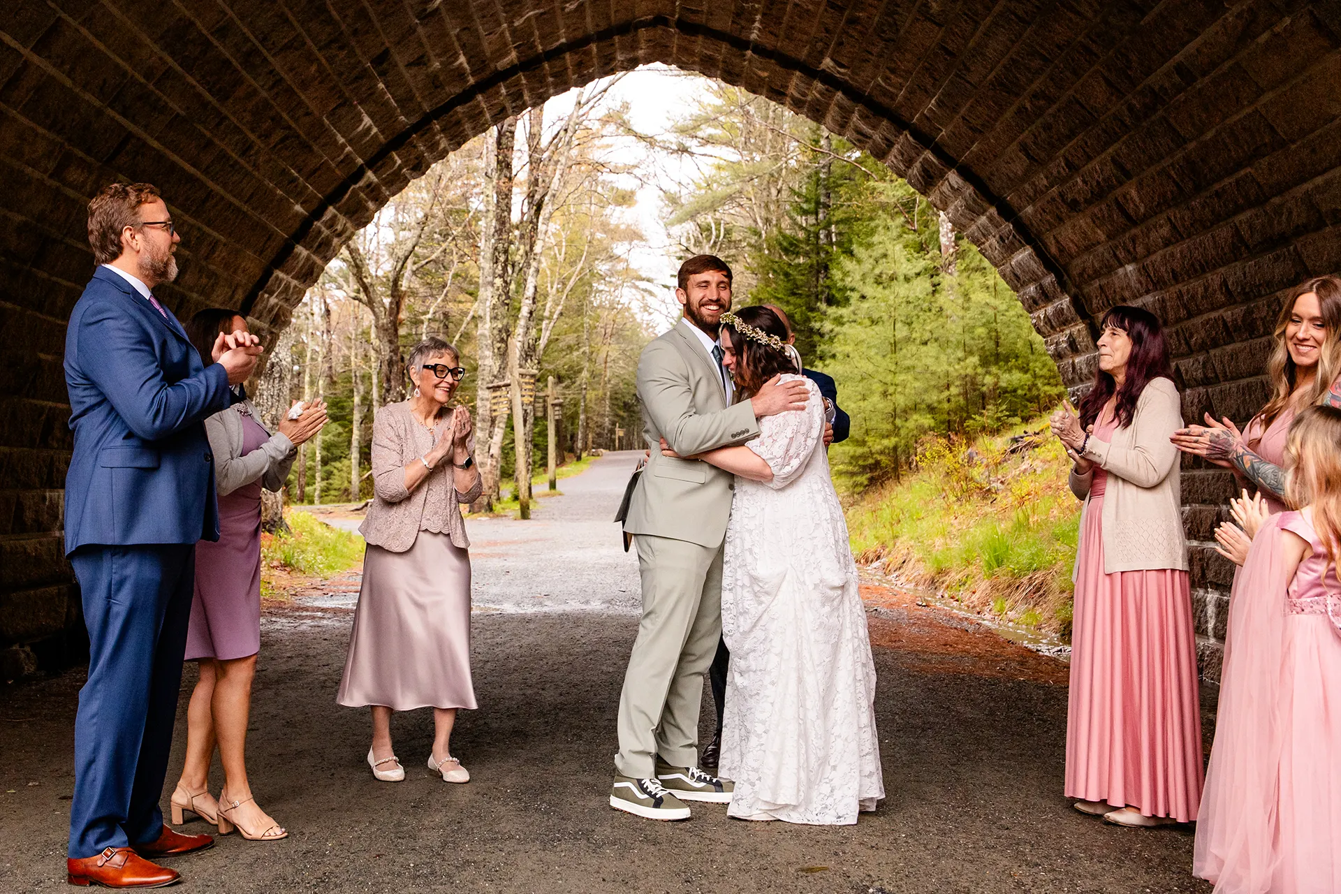 maine wedding photography mystic andrew 08 A bride and groom hug while guests clap during an elopement ceremony at Eagle Lake in Acadia National Park near Bar Harbor, Maine.