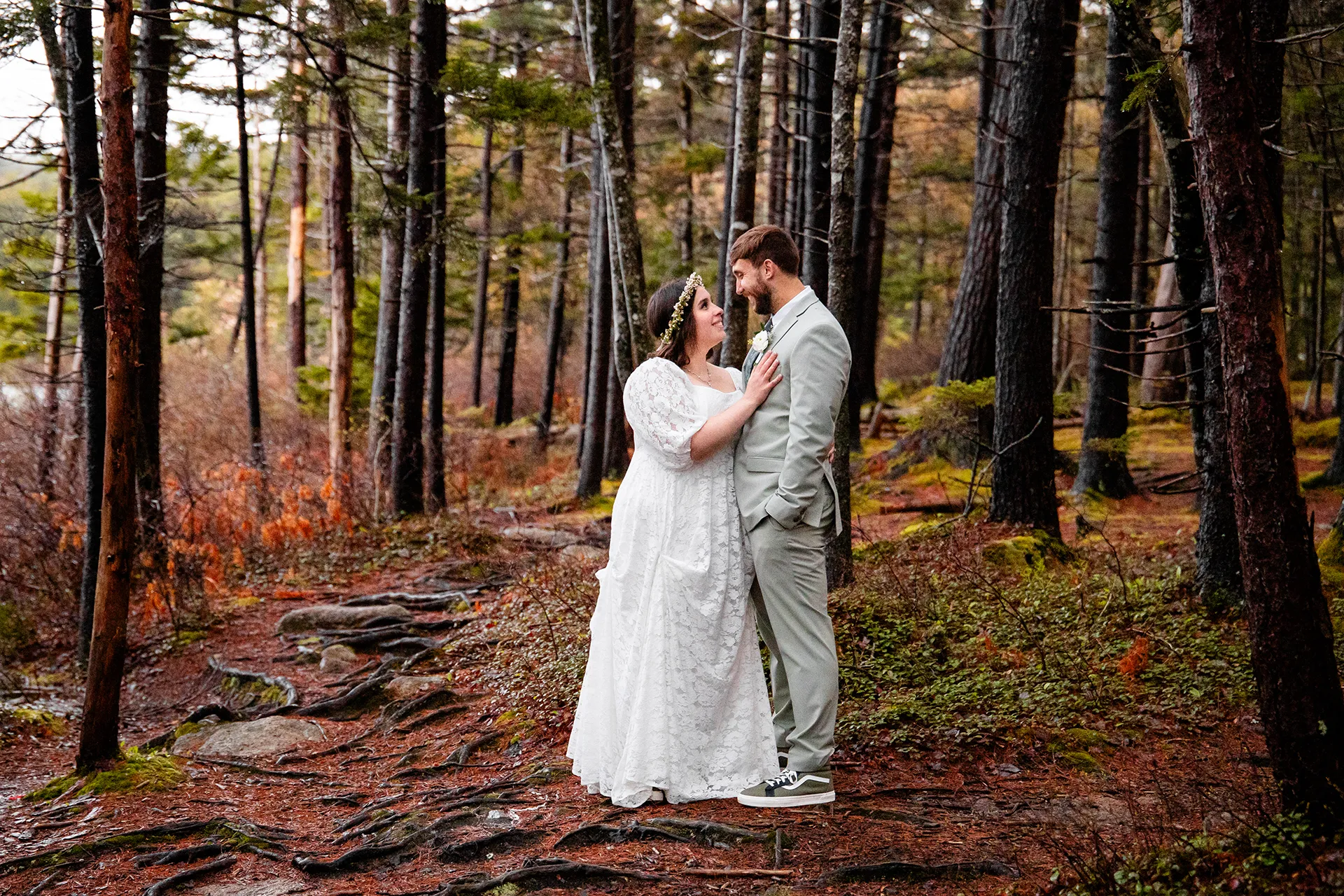 maine wedding photography mystic andrew 17 A married couple smile at each other while posing in the woods at Eagle Lake in Acadia National Park near Bar Harbor, Maine.