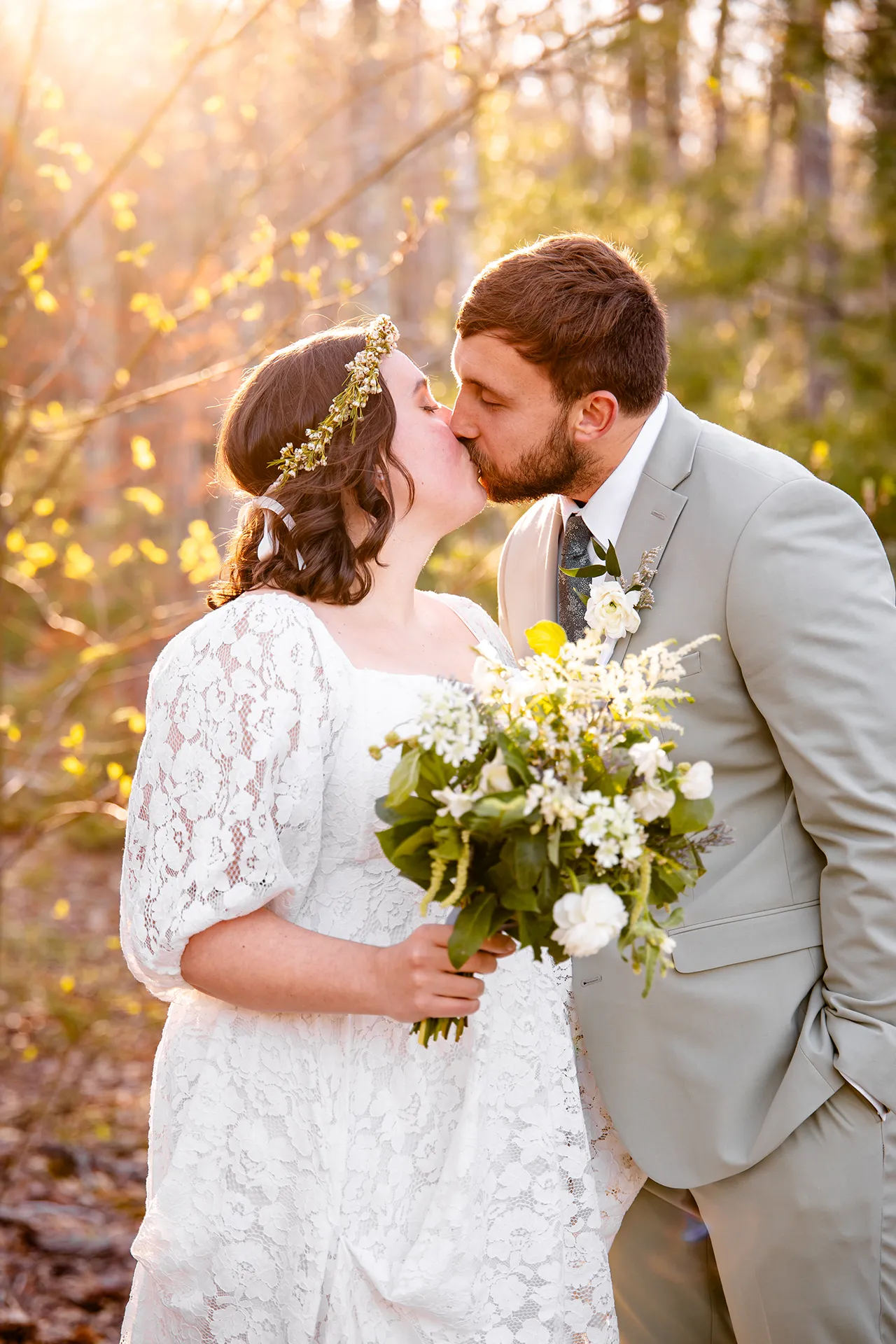 maine wedding photography mystic andrew 18 A bride and groom kiss as they sun shines behind them at the Jesup Path in Acadia National Park near Bar Harbor, Maine.