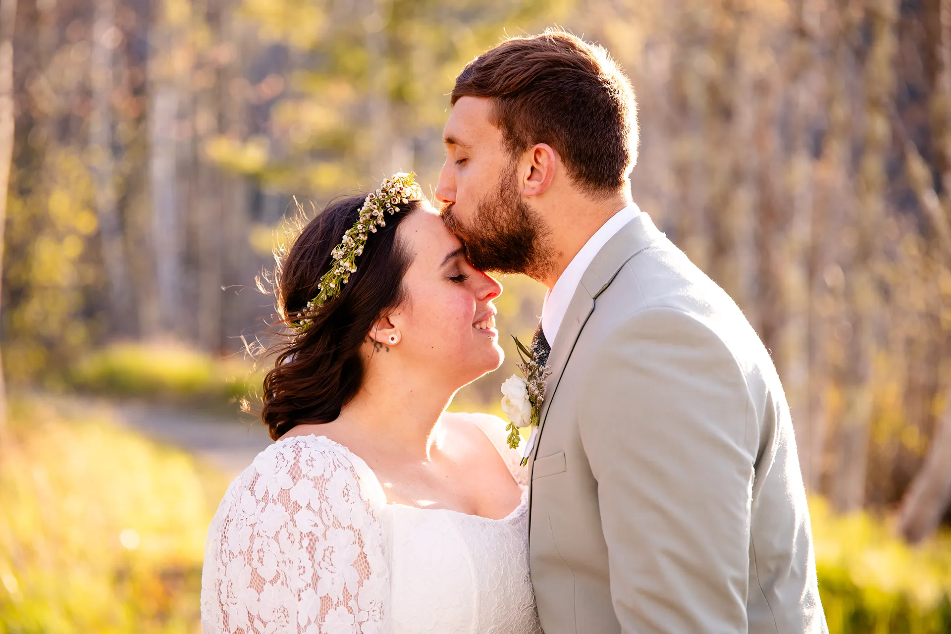 maine wedding photography mystic andrew 26 A groom kisses a bride on the head during wedding portraits on the Hemlock Trail in Acadia National Park near Bar Harbor, Maine.