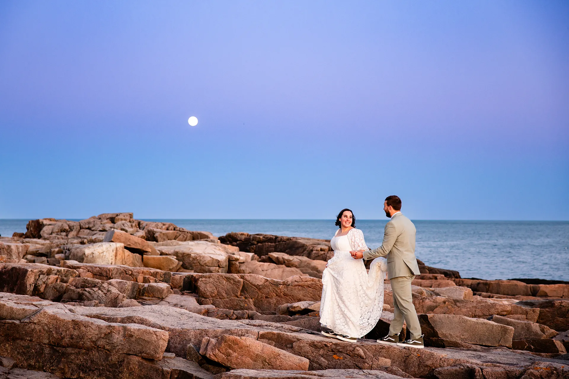 maine wedding photography mystic andrew 33 A newly married couple walk along a cliff during sunset wedding portraits at Otter Point in Acadia National Park near Bar Harbor, Maine.